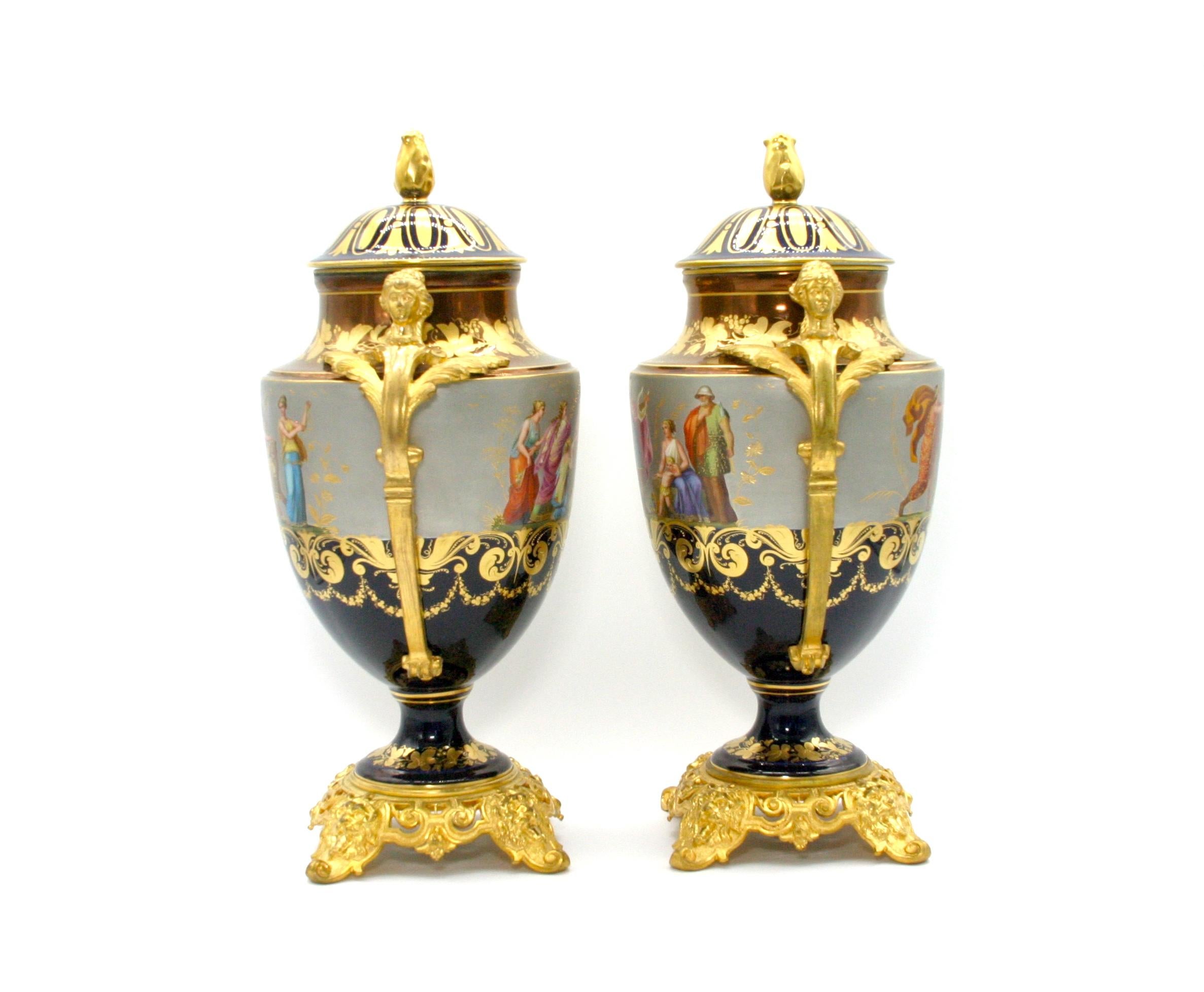 19th century gilt bronze mounted hand painted and crafted porcelain pair decorative covered urn / vase. Each urn features decorated figural design with bronze side handles with Greek mythological scenes. Each one in great antique. Minor wear