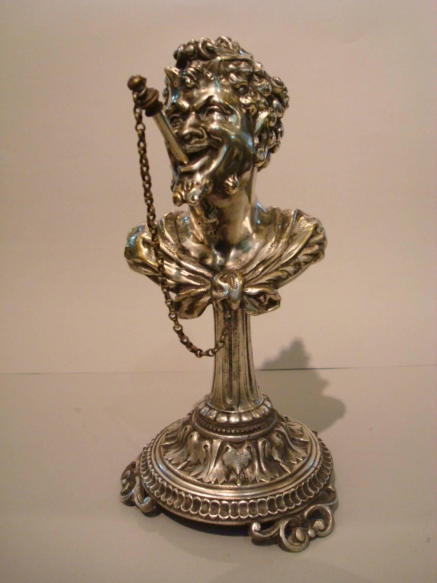 Very unusual 19th century silvered bronze tobacco cigar table lighter. The finely cast and chiseled features of a gilt bronze satyr clenching a ‘cigar’ shaped wick holder in his mouth, the head has a reservoir, once filled with oil can be used to