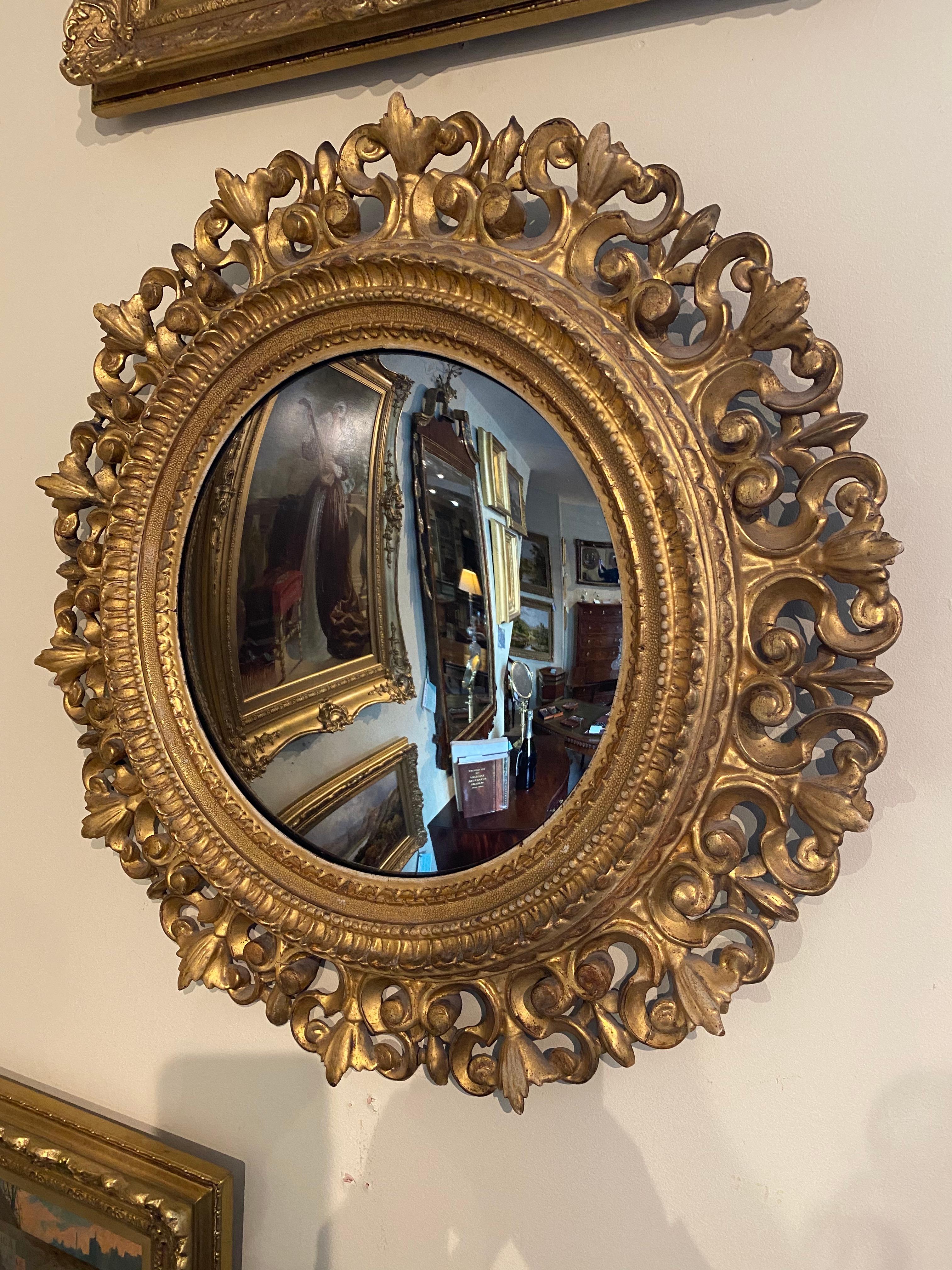 This Beautifully Presented Ornate Circular Convex Gilt Mirror In The Florentine Style Dates Back To The Mid 1800s. Although English In Construction, Its Carved Giltwood And Moulded Gesso Patterns Are Heavily Influenced By The Florentine Style Of The