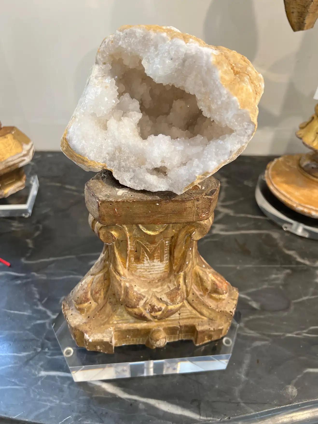 A beautiful architectural remnant has been re-worked into a pedestal for a polished geod. All is then placed on a customized acrylic base for a very sophisticated, finished look.