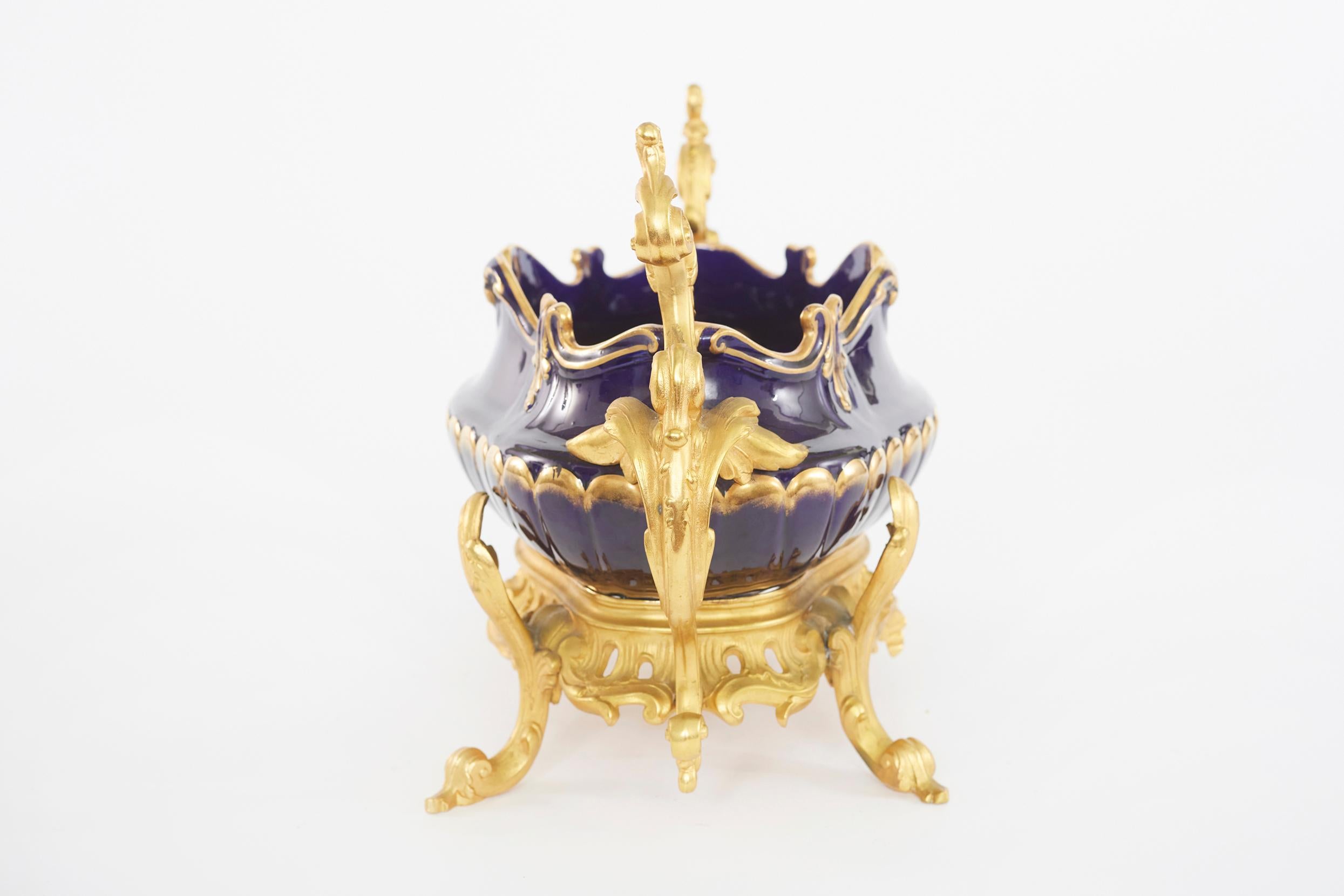 19th Century hand painted gilt gold design porcelain with footed bronze mounted decorative centerpiece with side handles. The centerpiece is in great condition. Minor wear consistent with age / use. The piece stands about 18 inches long X 11 inches