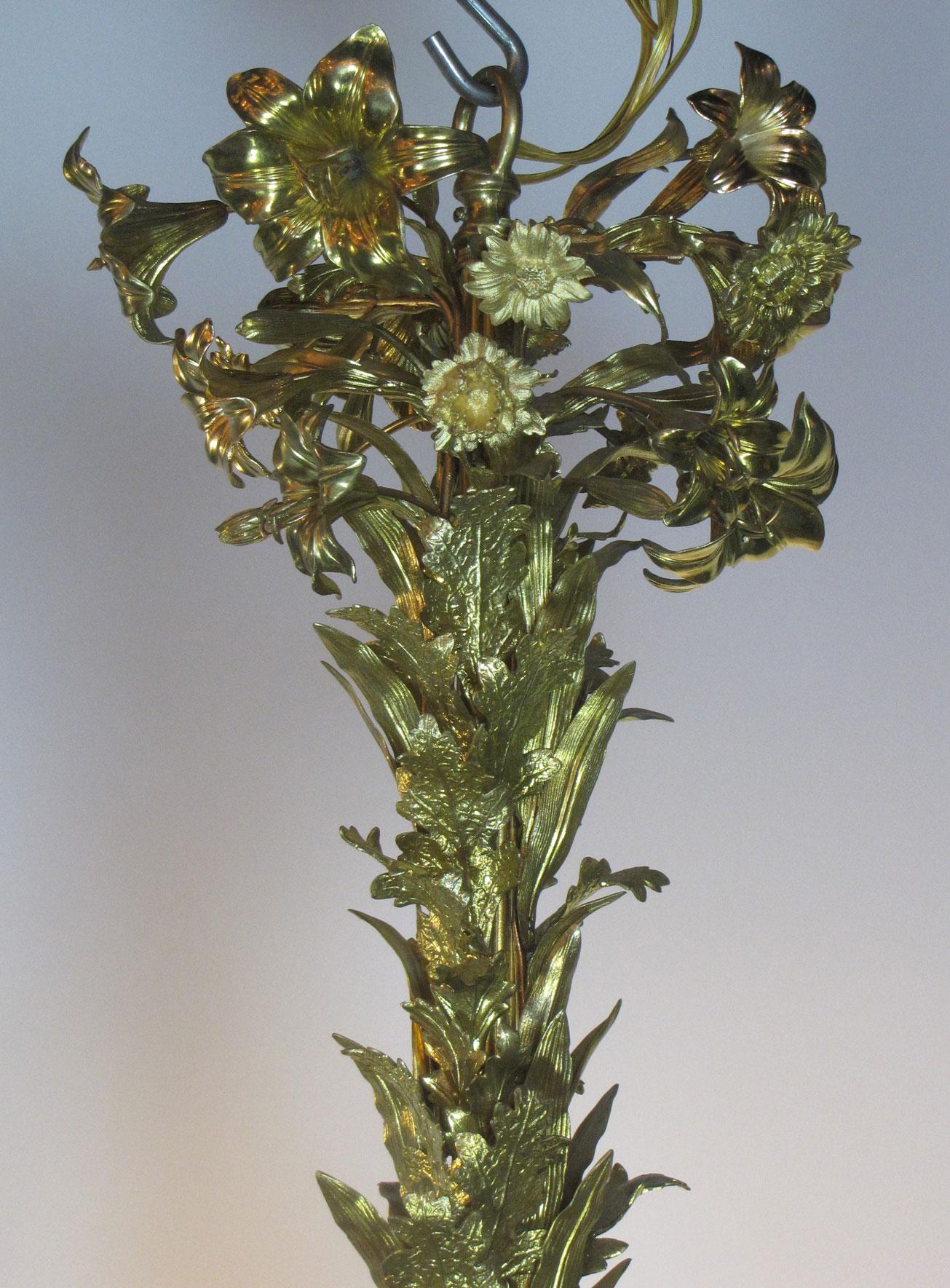 The opulence of the gilded era is celebrated by this chandelier in excess with not only gilded lilies, but chrysanthemums and poppies as well. It was imported from France during the late 19th Century and hung in the mansion of David Sears at 132