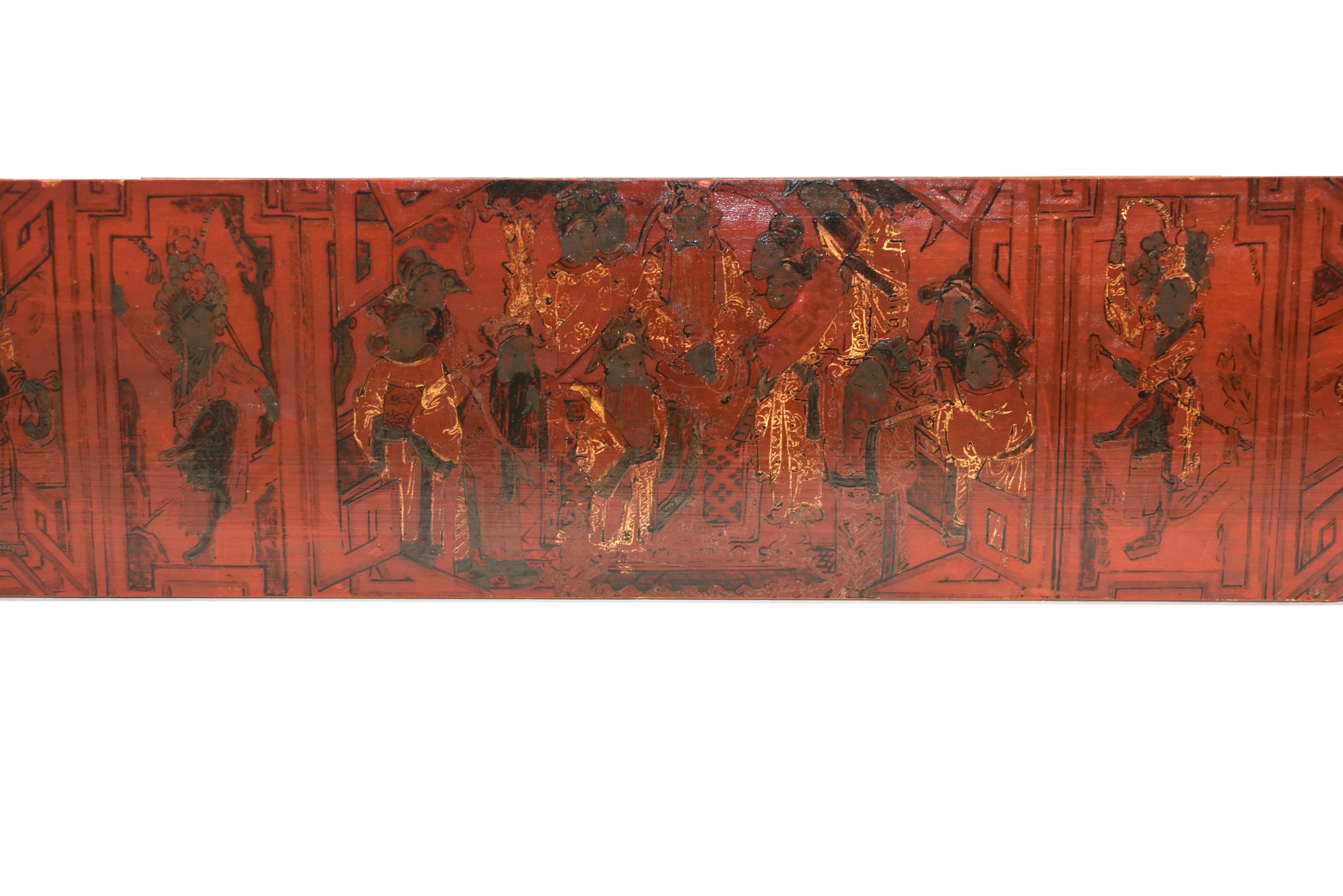 A beautiful red lacquered, solid wood fragment painted with an opera scene of victory celebration, featuring various figures dressed in official uniforms and crowns. Remnant gold leaf visible throughout the painting, especially on clothes and