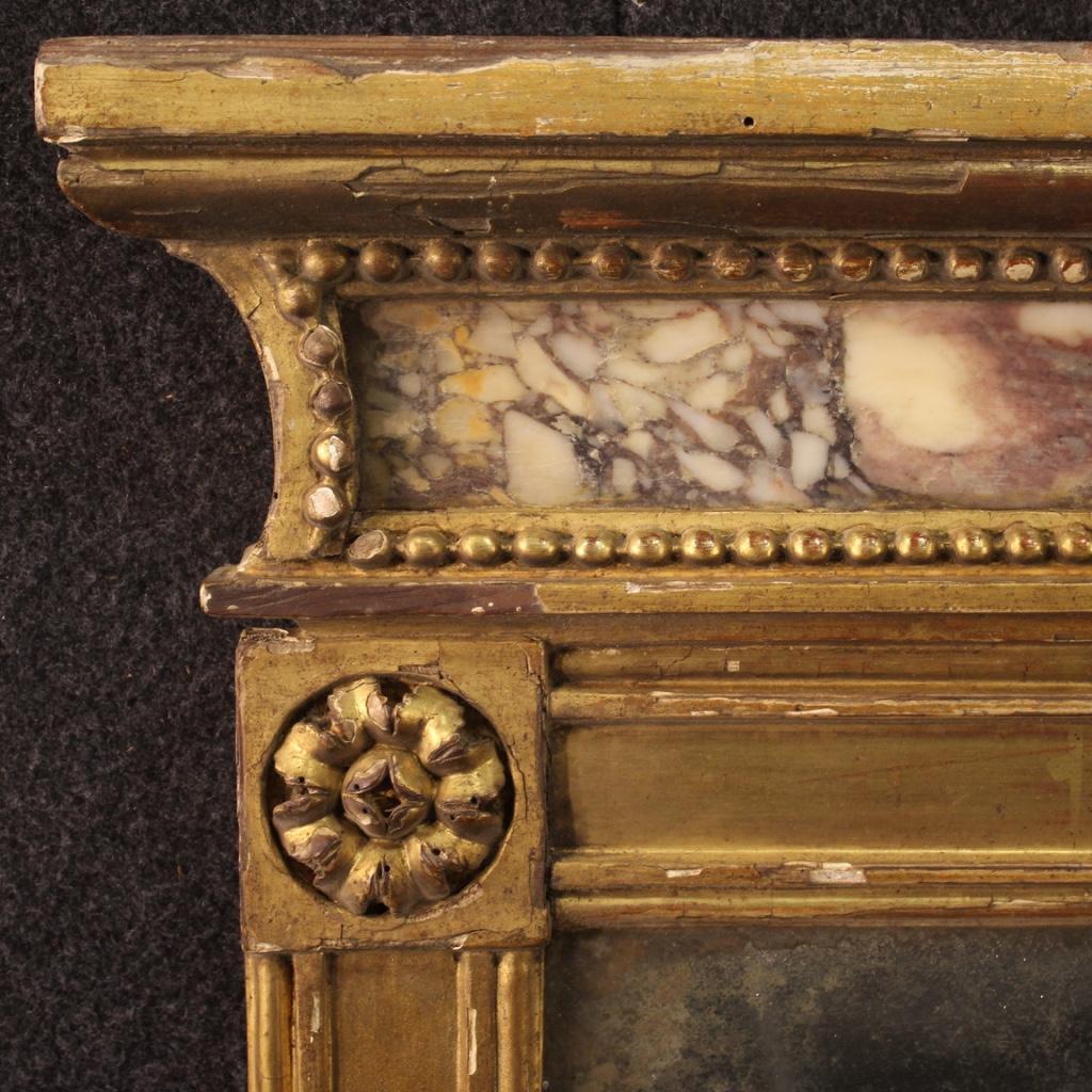 Antique Italian mirror from the first half of the 19th century. Furniture of great quality and pleasant decor in carved and gilded wood with embedded marble in the upper part. Marble in excellent condition, without cracks or chips. Original mercury