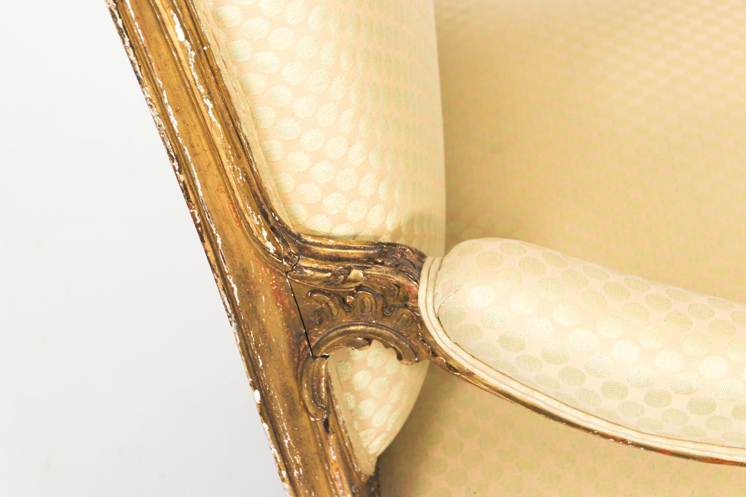 Giltwood chaise lounge armchair with new upholstery, circa 19th century.