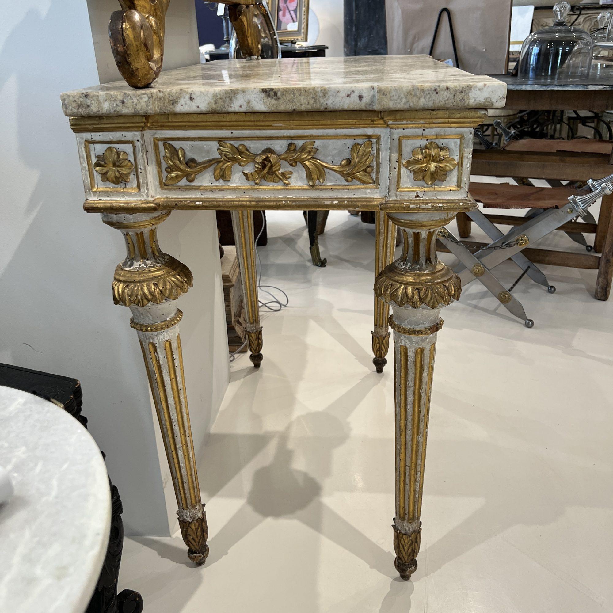 Imbue your home with a sense of historical grandeur with this 19th Century Italian Giltwood Console with Marble Top. Its radiant giltwood, intricate carvings, and luxurious marble top create a piece that is both functional and visually striking.