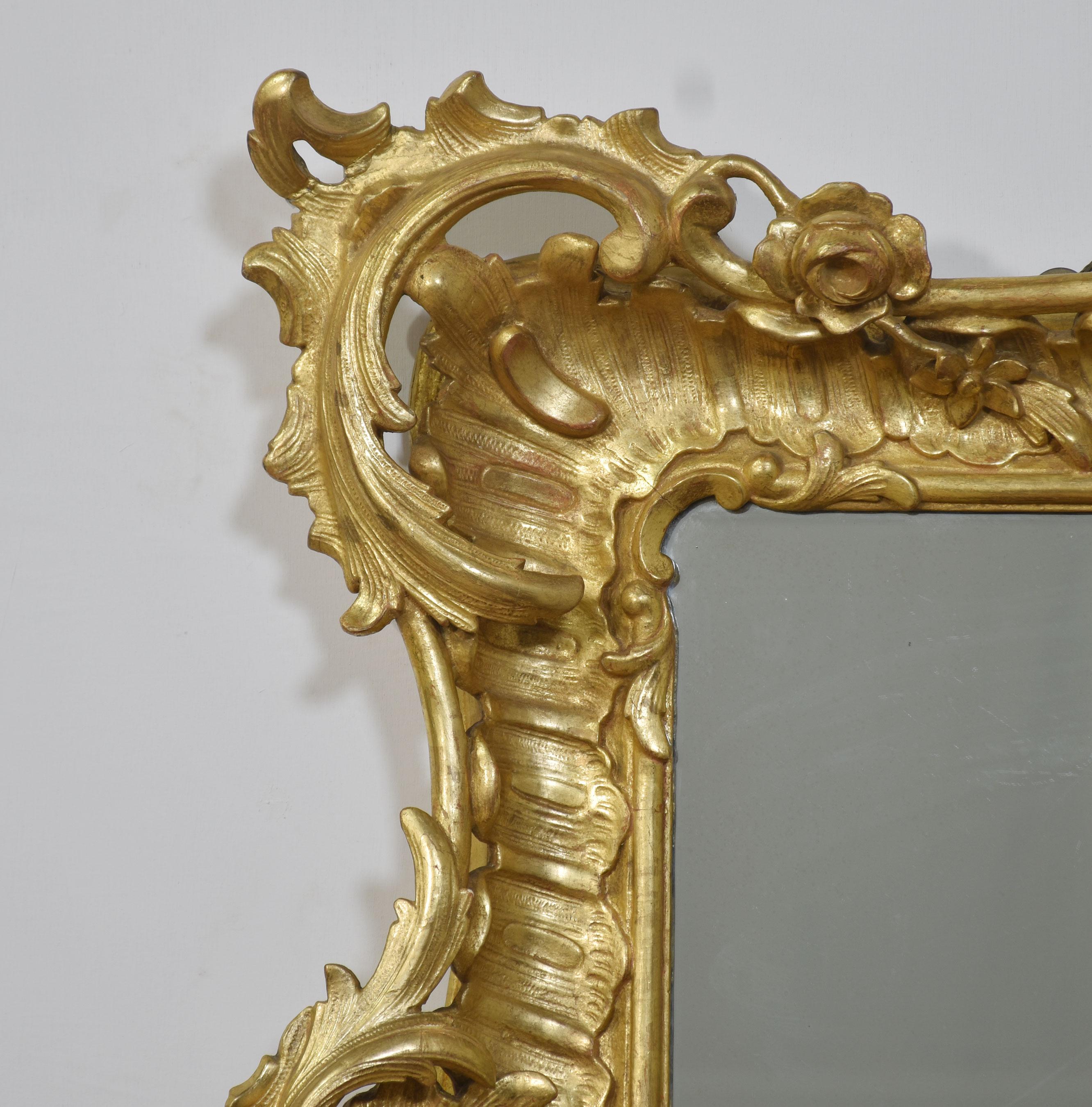 Large 19th-century gilt-wood wall mirror in the rococo manner the scrolling foliated frame surrounding the original mirror plate.
Dimensions
Height 39.5 Inches
Width 46.5 Inches
Depth 5 Inches