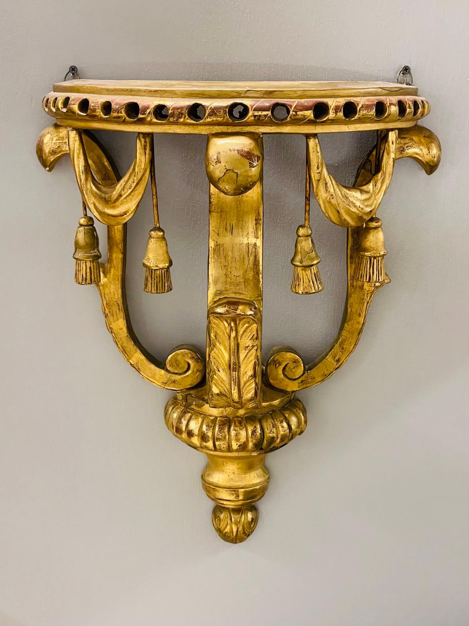 19th Century Gilt Wood Wall Bracket or Shelf, Water Gilt

A petite finest quality water gilt late 19th century wall braket having demi lune form with fine tassle and shell carvings. Strong and strudy in very nice original condition.

H21