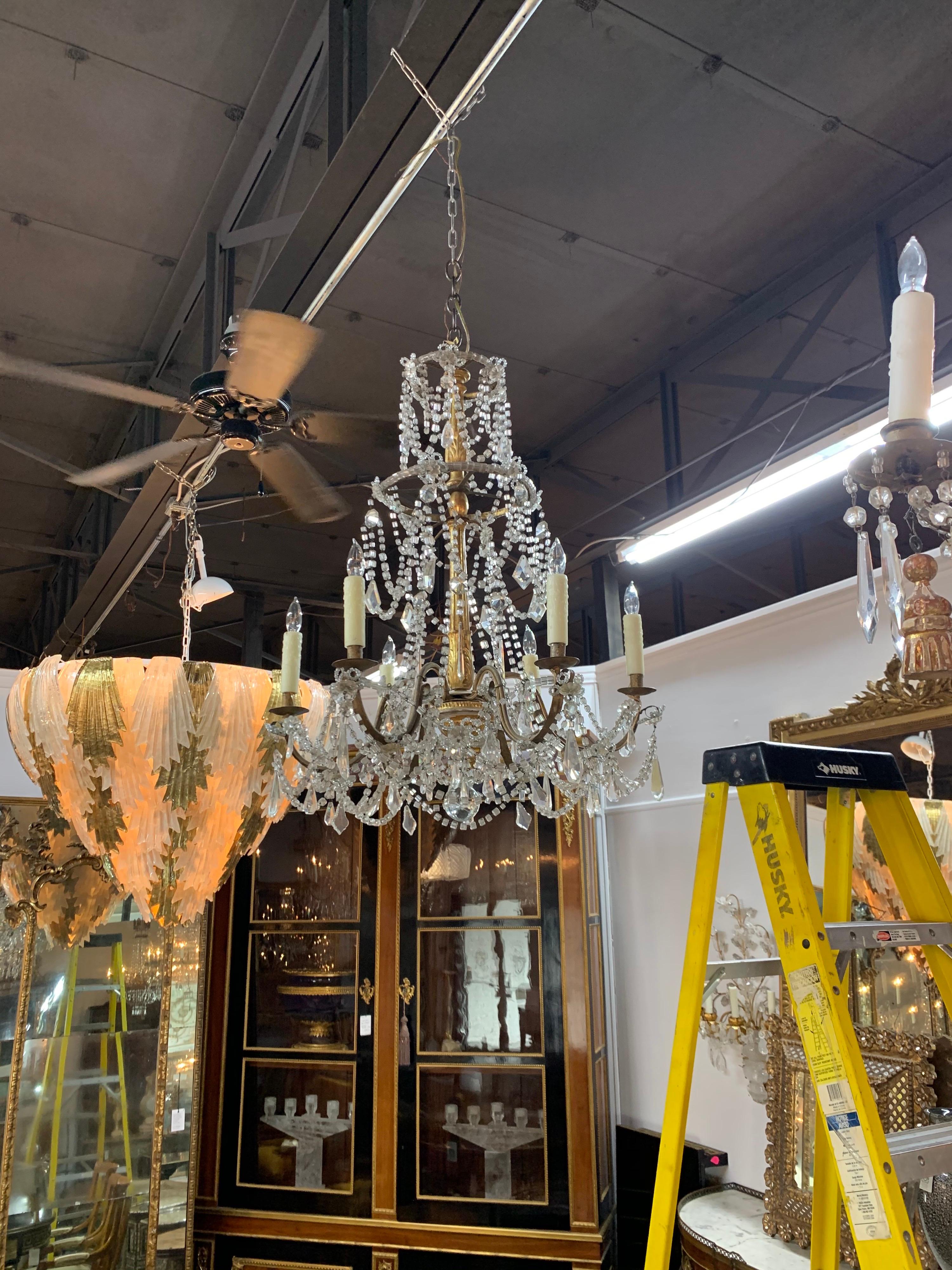 Elegant 19th century giltwood and crystal 6-light chandelier. This fixture is draped with beautiful crystal beads and prisms. The carved giltwood base is really pretty as well. A classic beauty!