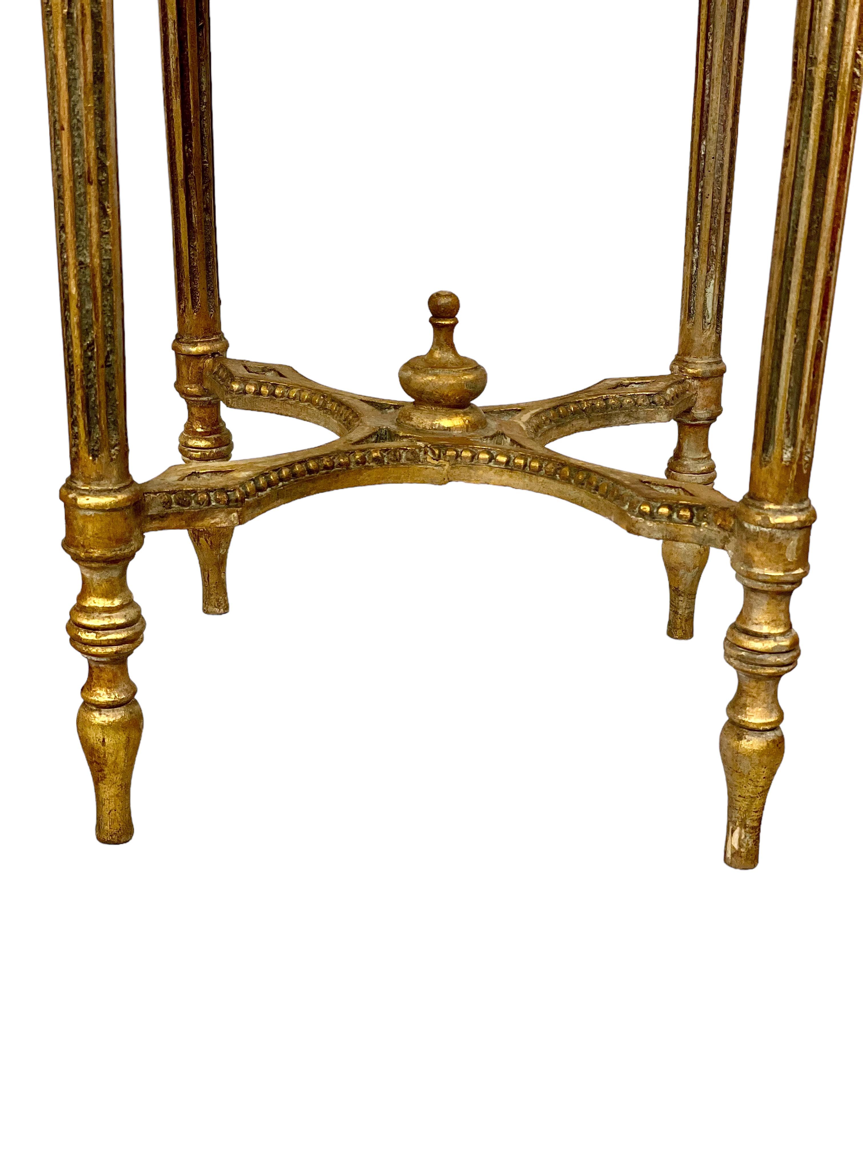 This fabulous Louis XVI-style giltwood and marble gueridon table, or plant stand, dates from the 19th century and features an impressive moulded-edged top tray of dark green Pyrenean marble. This sits above a profusely carved and highly decorative