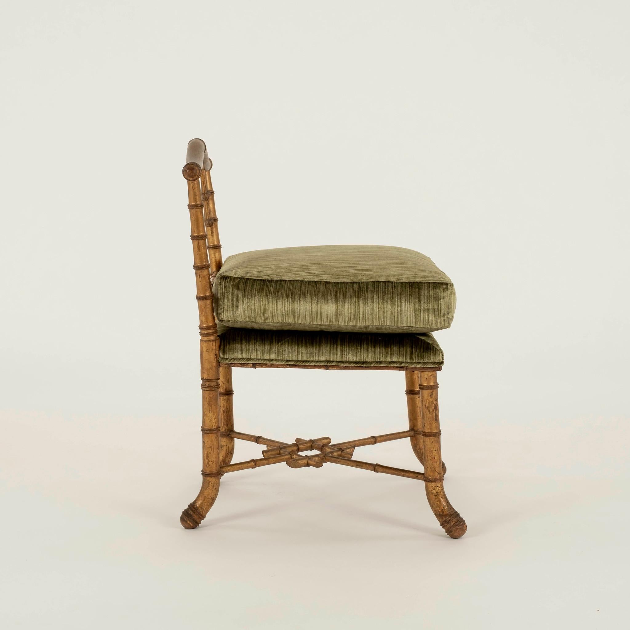 19th century giltwood bamboo chair newly upholsterd in a beryl green striated silk velvet.