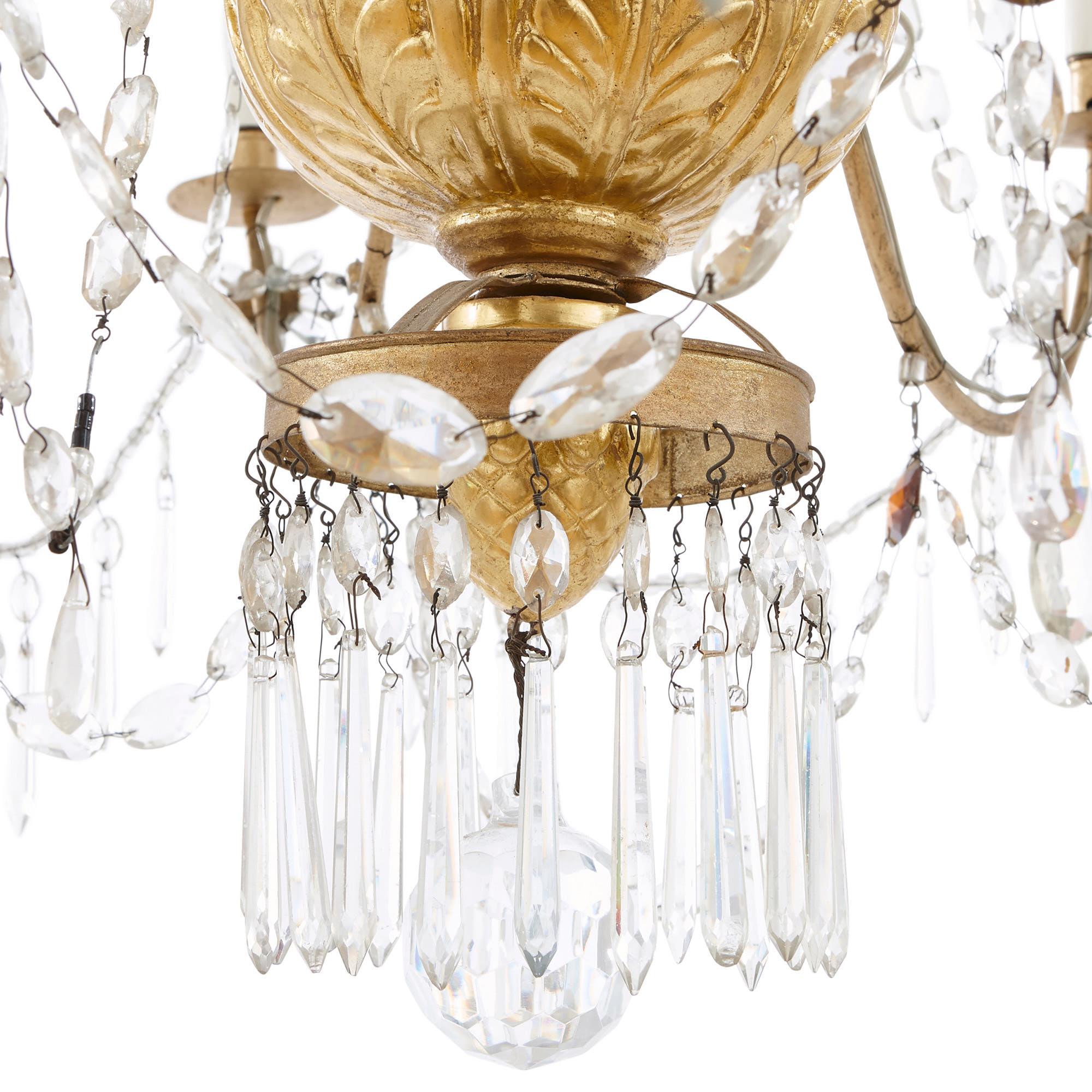 This Italian chandelier is a beautiful, grand piece of design, composed of finely-carved giltwood, faceted clear glass, and jewel-like colored glass pendants. The item will look wonderful suspended from the ceiling of a grand interior, either