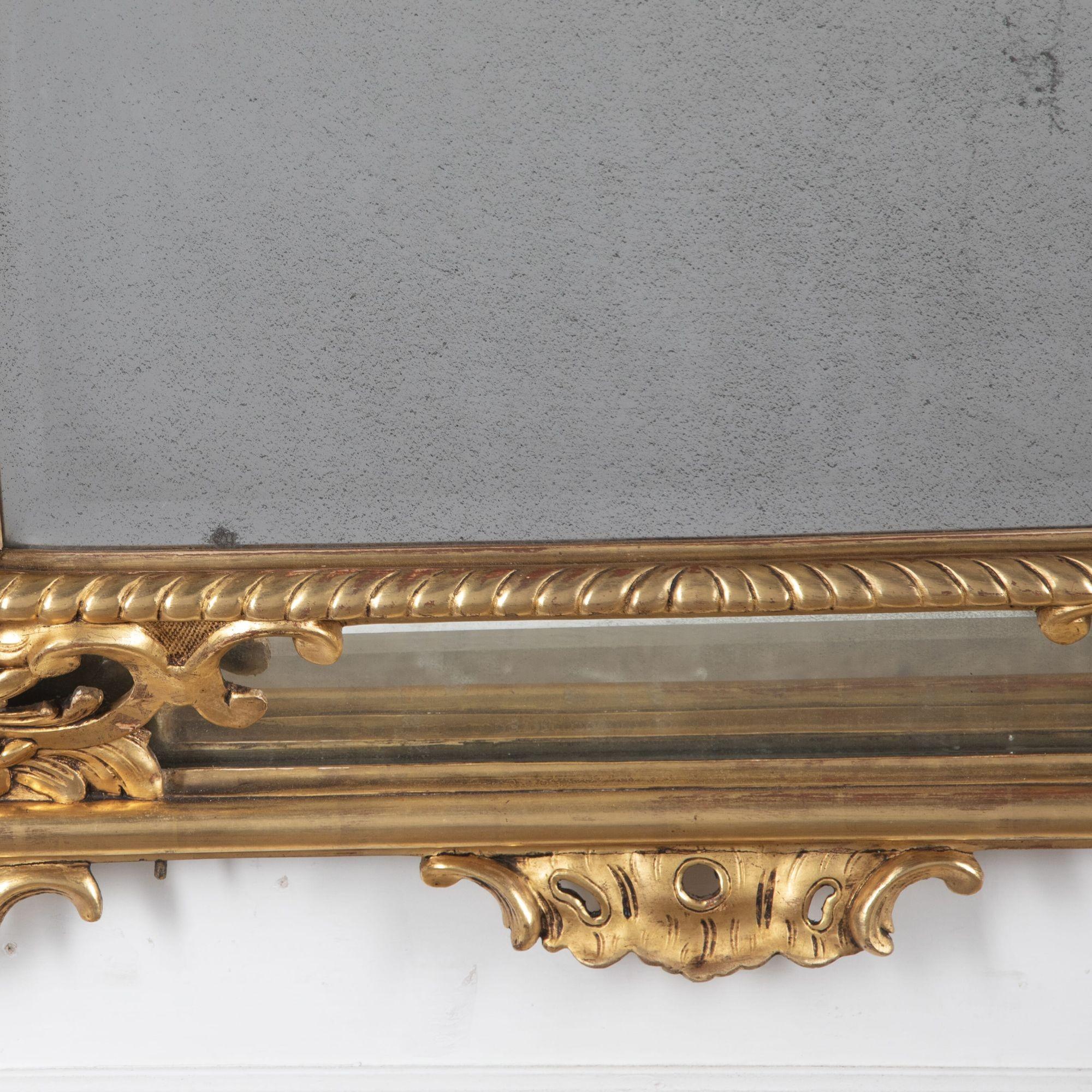 19th Century French large gilt wood cushion mirror of fine quality.
With restoration.