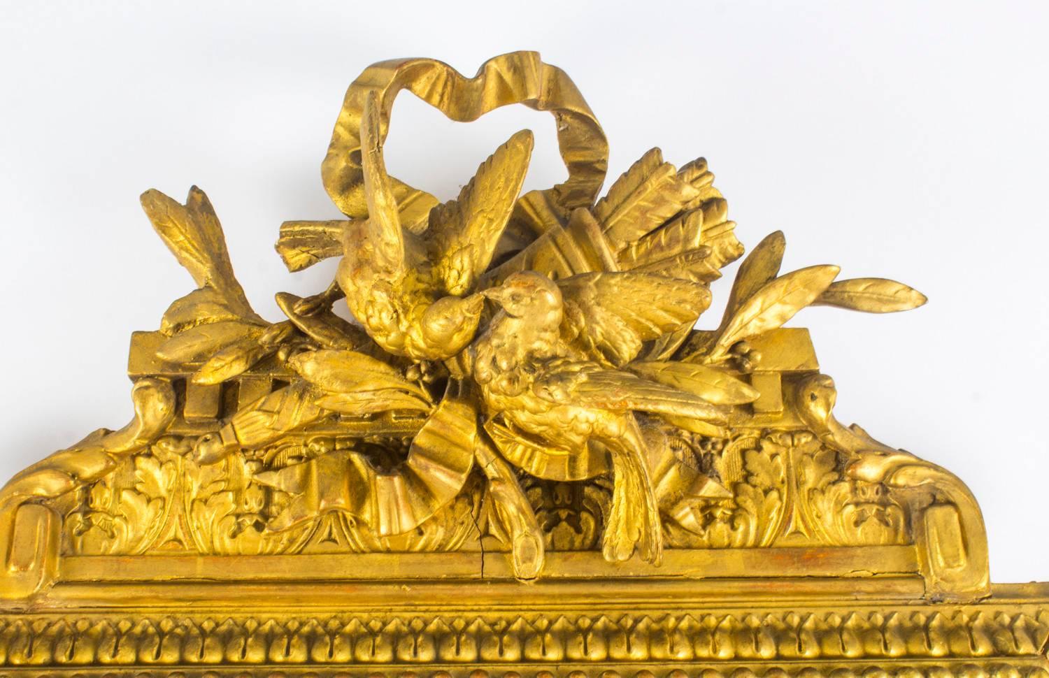 A finely carved antique 'Cushion' giltwood mirror in the Louis XIV style, circa 1870 in date.

The rectangular mirror is framed by egg and dart marginal side plates with the same inner frame.
 
The frame is surmounted with a striking carved giltwood