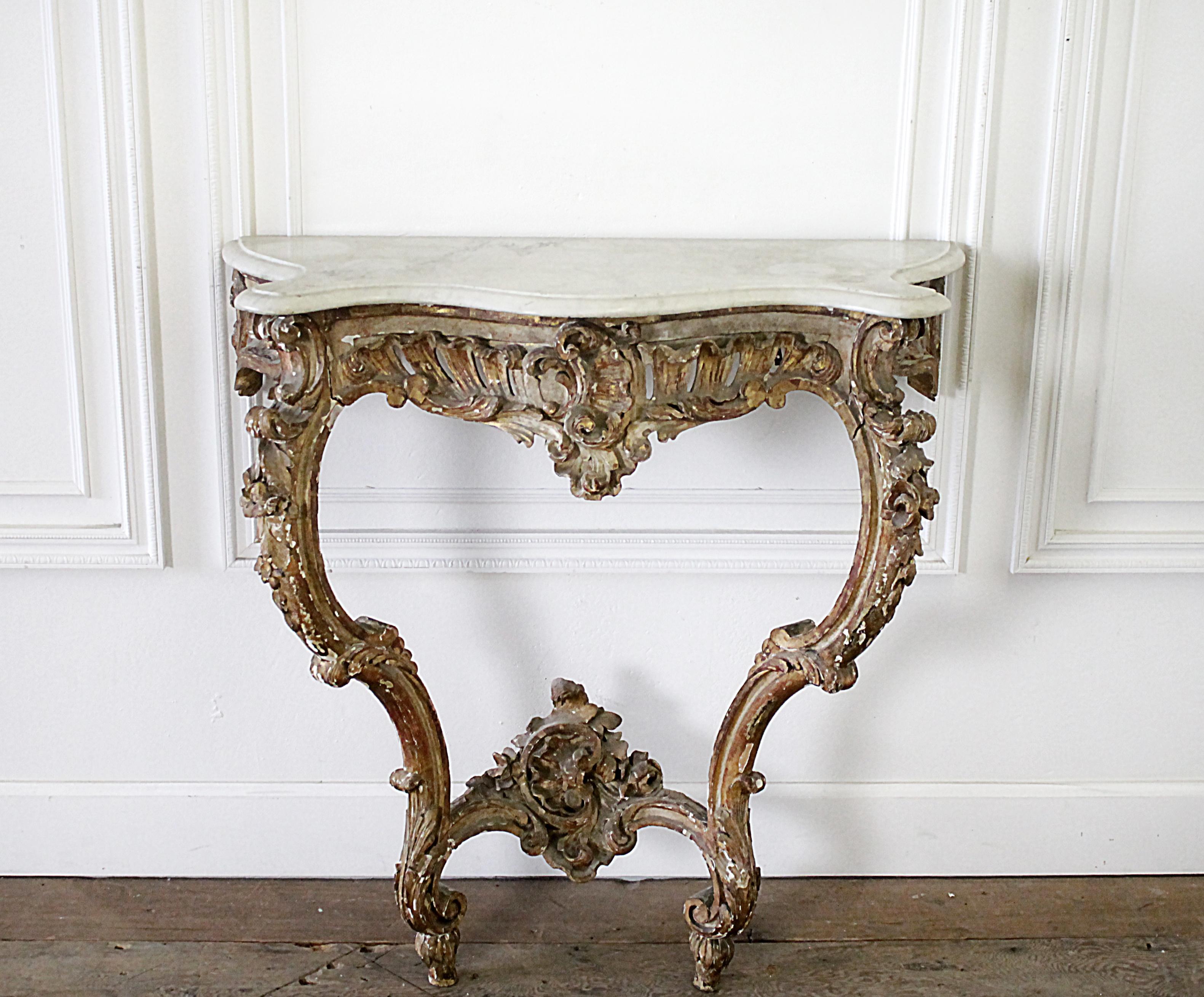 19th century giltwood Louis XV style console with marble top
Very patina’d this console table is beautifully carved, with a white and grey Carrara marble top. The right leg has been repaired at some point, you can see there is a separation in the