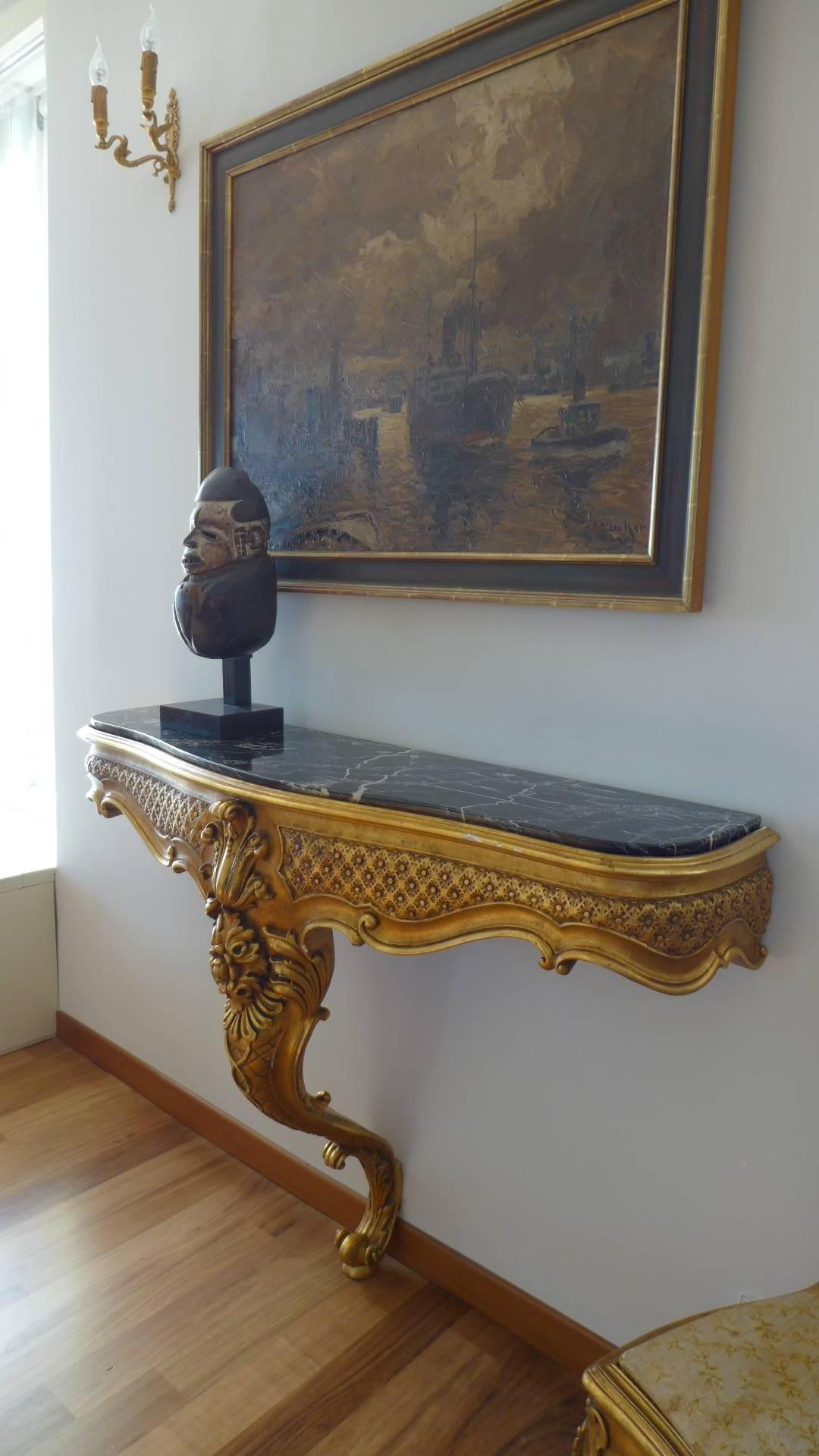 19th century giltwood black marble-top console table with very detailed carvings.
France,
circa 1860.