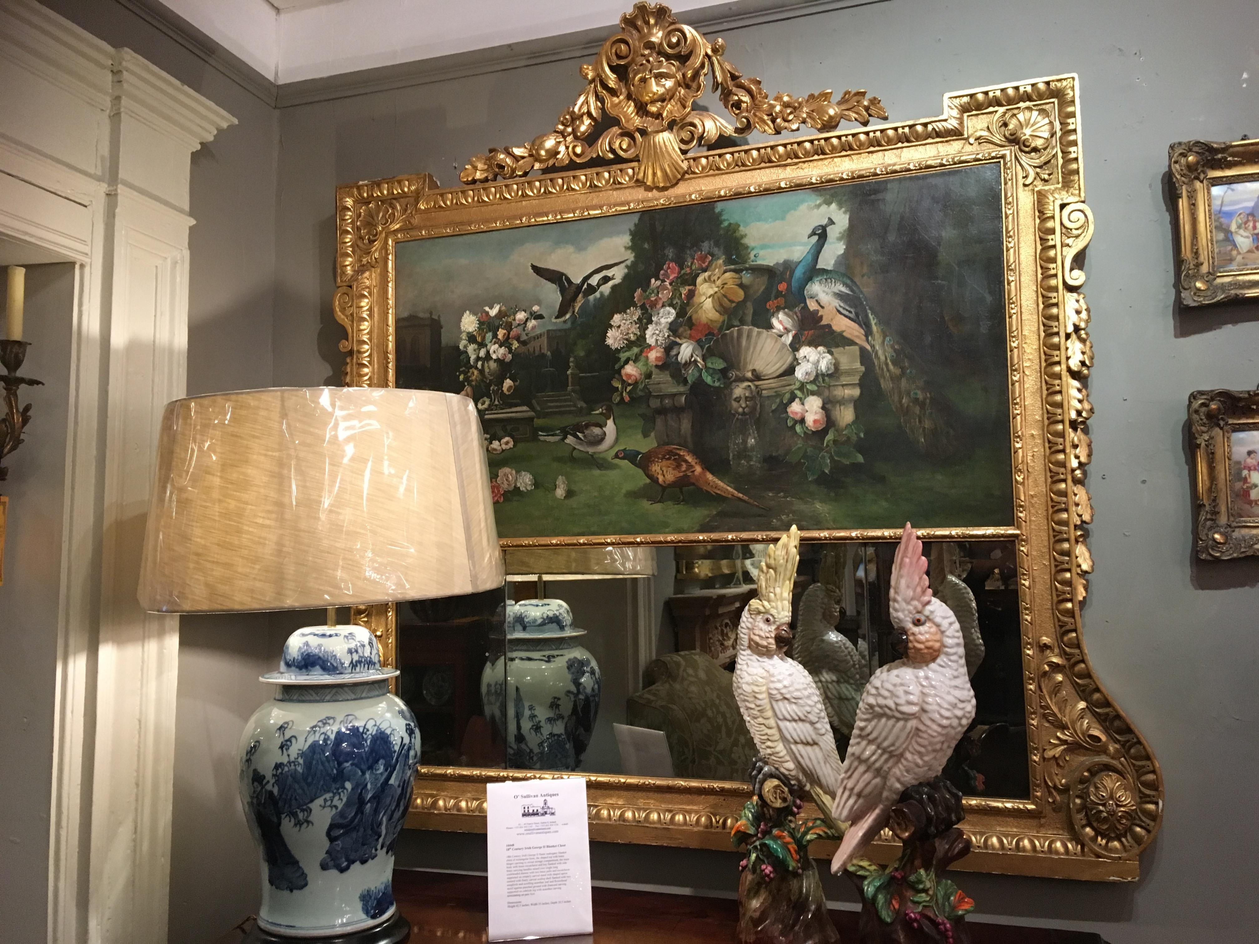 19th Century giltwood trumeau mirror of rectangular form, the period compartmental bevelled plate set within giltwood frame surmounted with oil on canvas painting depicting the garden grounds of a Neoclassical manor house with peacocks, ducks, urns,