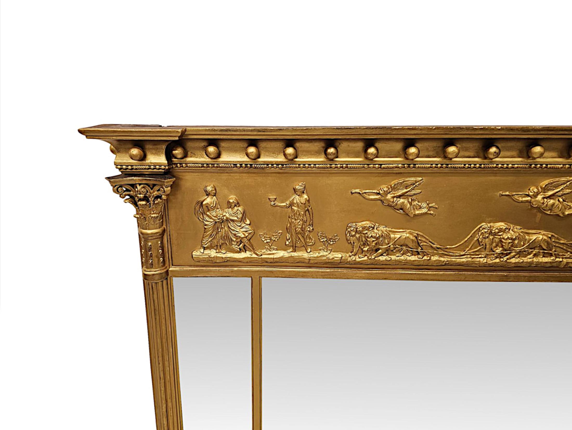 A stunning 19th Century giltwood tryptych compartmental overmantel mirror.  The finely hand carved, moulded and fluted giltwood frame of rectangular form is surmounted with an overhanging inverse breakfront stepped cornice pediment with applied