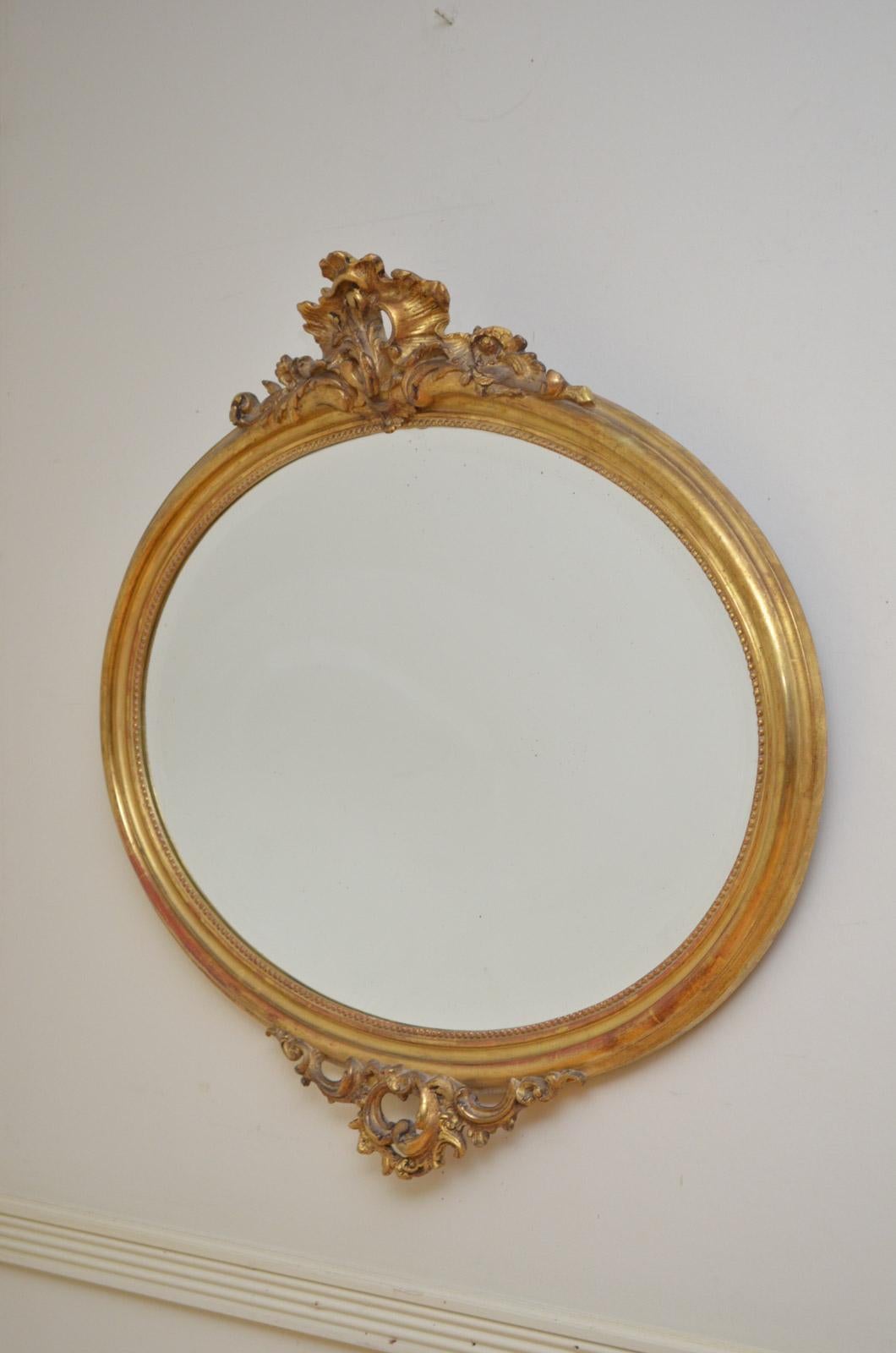 Sn4597 fine 19th century gilded mirror of oval form, having original bevelled edge glass in finely carved frame with centre cartouche to top and base. This antique mirror is in excellent original condition throughout, circa 1870
Measures: H 32