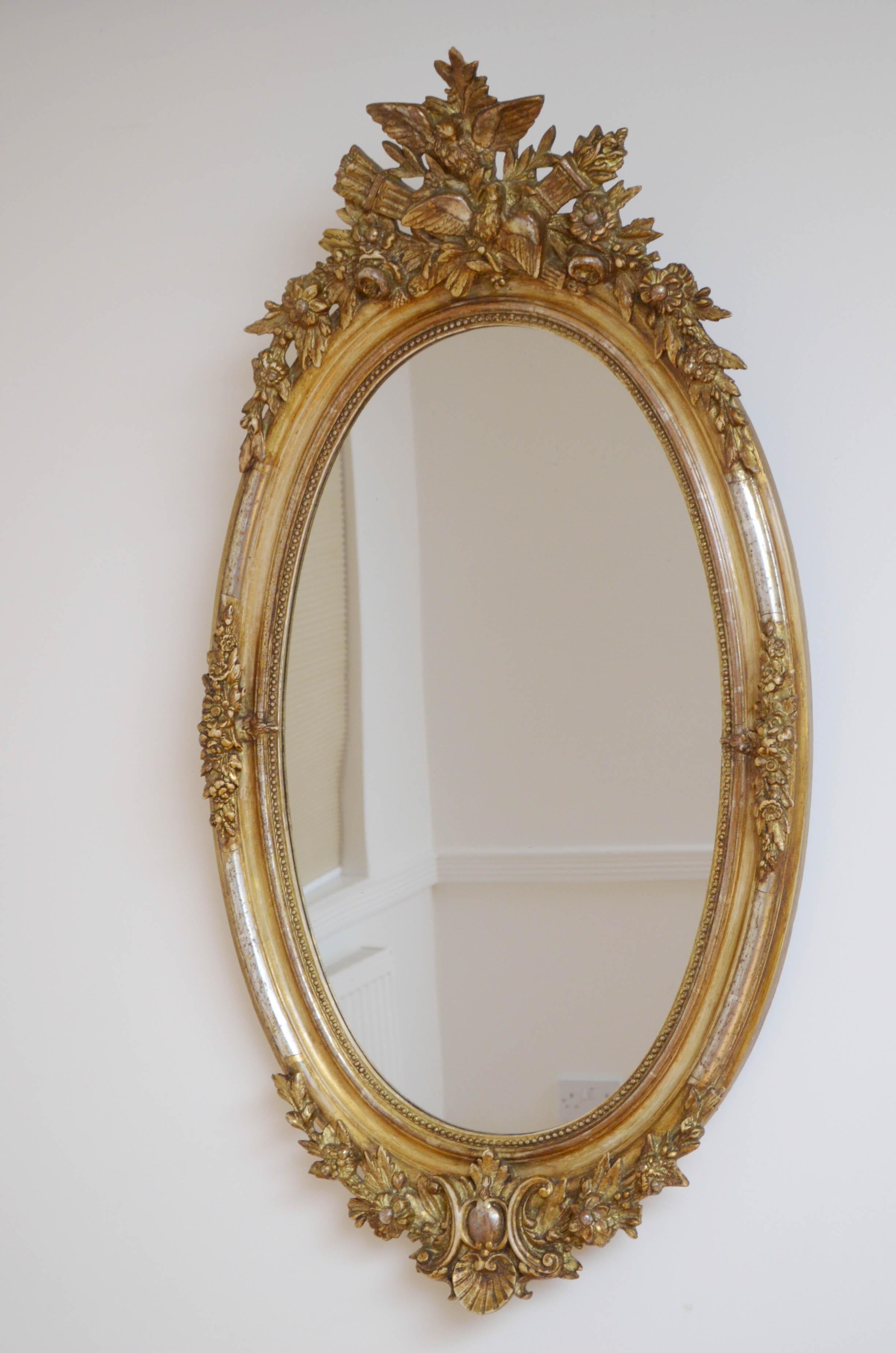 Sn4714 Attractive French mirror with original glass with some foxing in finely decorated silver frame with centre crest. This antique mirror is in original condition throughout, ready to place at home, circa 1870

Measures: H45.5? W24.5?