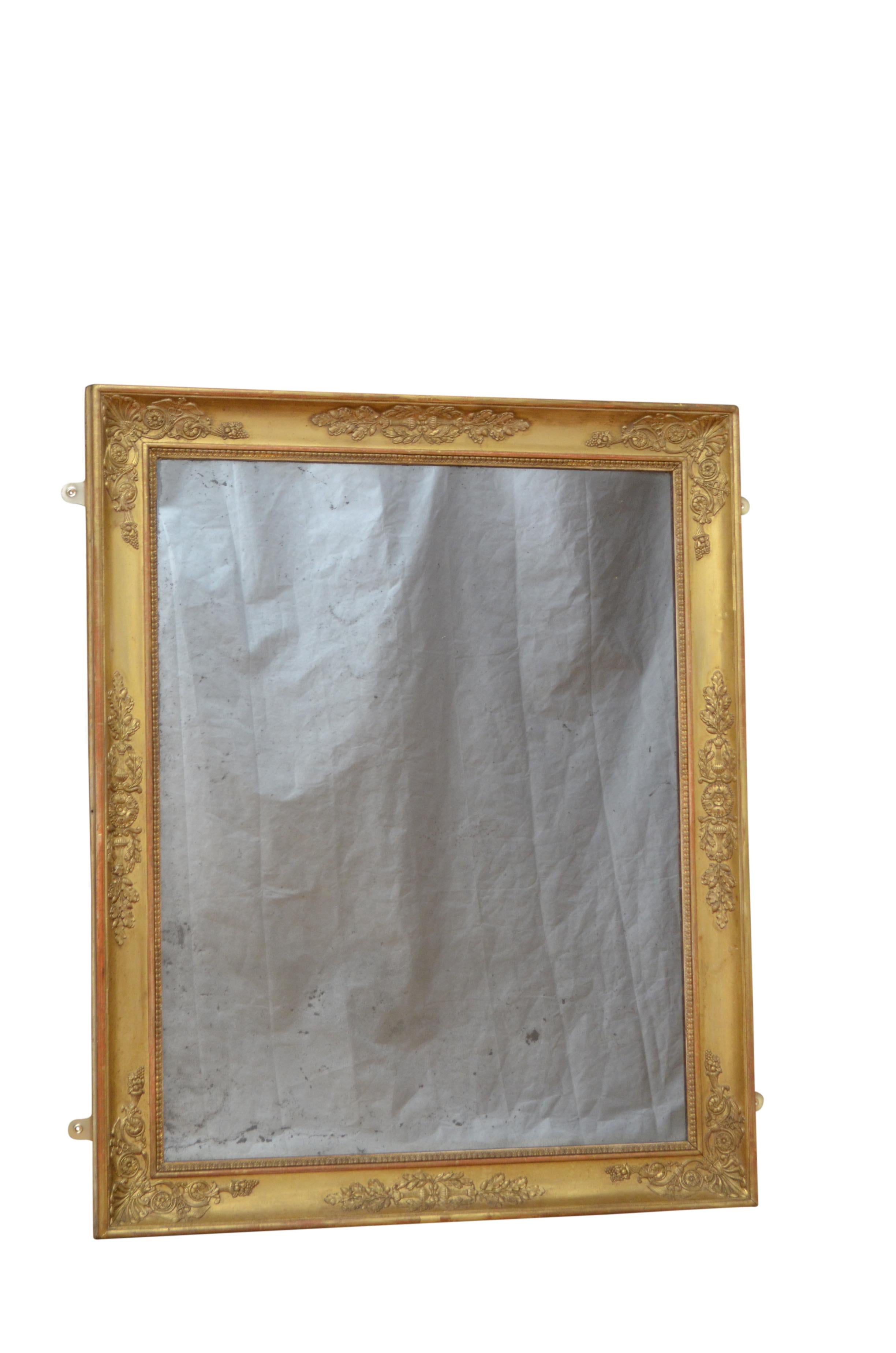 k00150 Fine XIXth century gilded wall mirror which can be positioned horizontally or vertically, having foxed glass in carved gilt frame decorated with intricate floral designs including oak leaf with acorns, horn of plenty and caduceus which is the