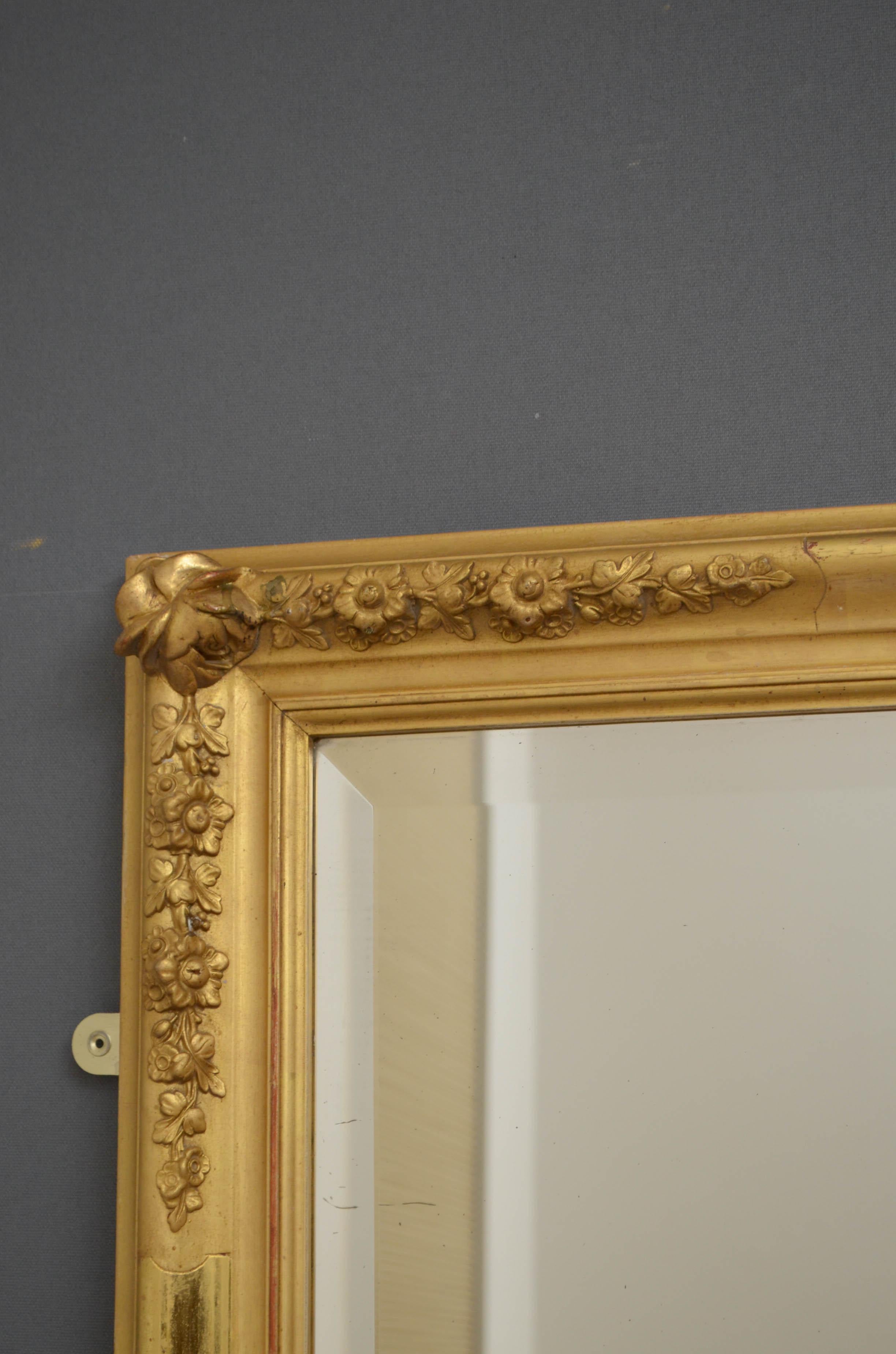 Sn4710 large 19th century giltwood wall mirror, having original bevelled edge glass with some foxing in finely decorated gilded frame. This antique mirror retains original glass, gilt and backboard, all in excellent home ready condition. Can be