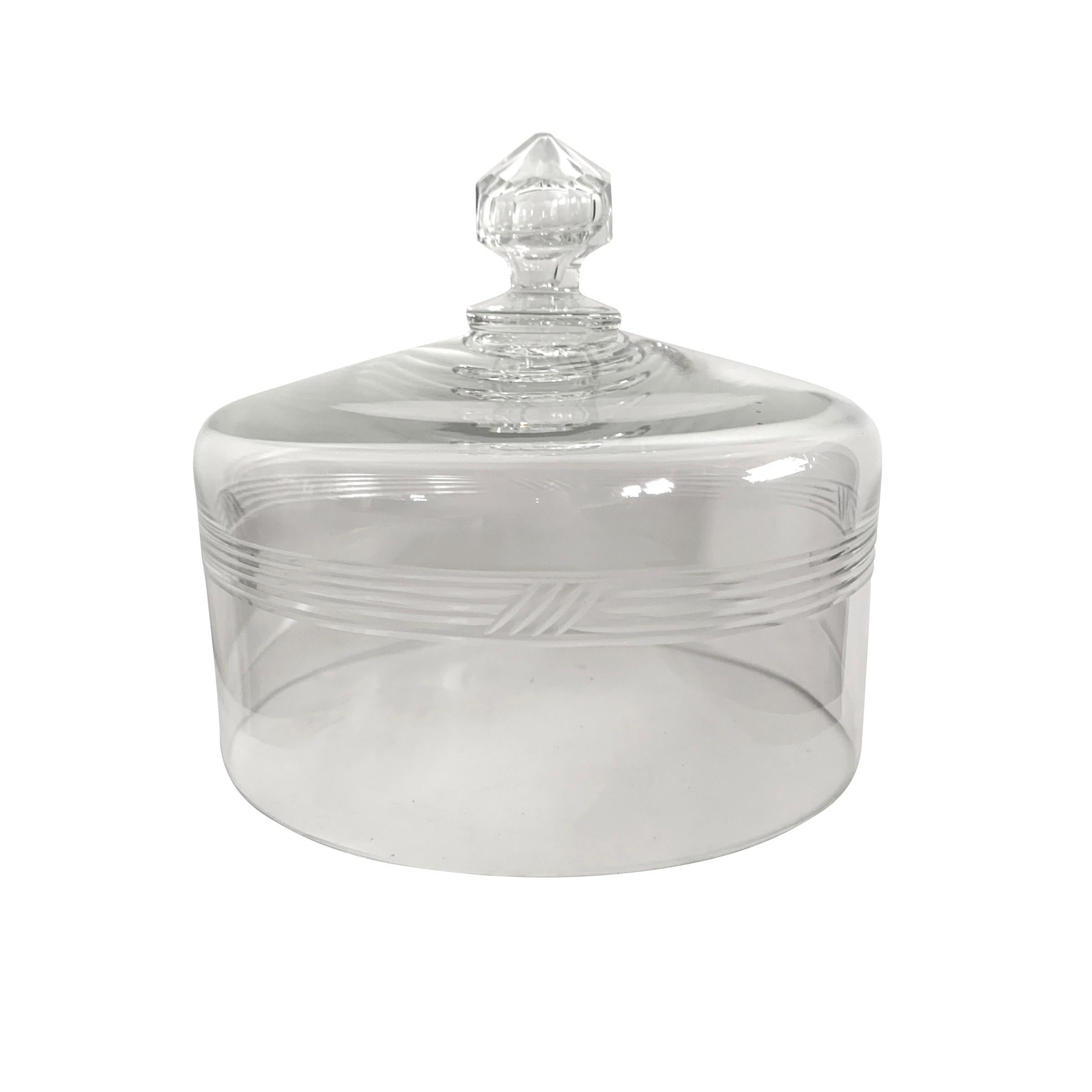 A wonderful 19th century English cut crystal cheese dome with captured bubble in the handle, and cut with several horizontal rings around the perimeter of the dome, resting atop an eight-sided spongeware plate.