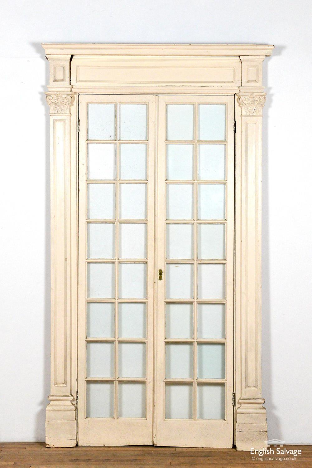 19th Century pine double glazed doors in a decorative surround. Original glass present. Some scuffs and splits commensurate with age Doors without surround measure 218cm high x 97cm wide.