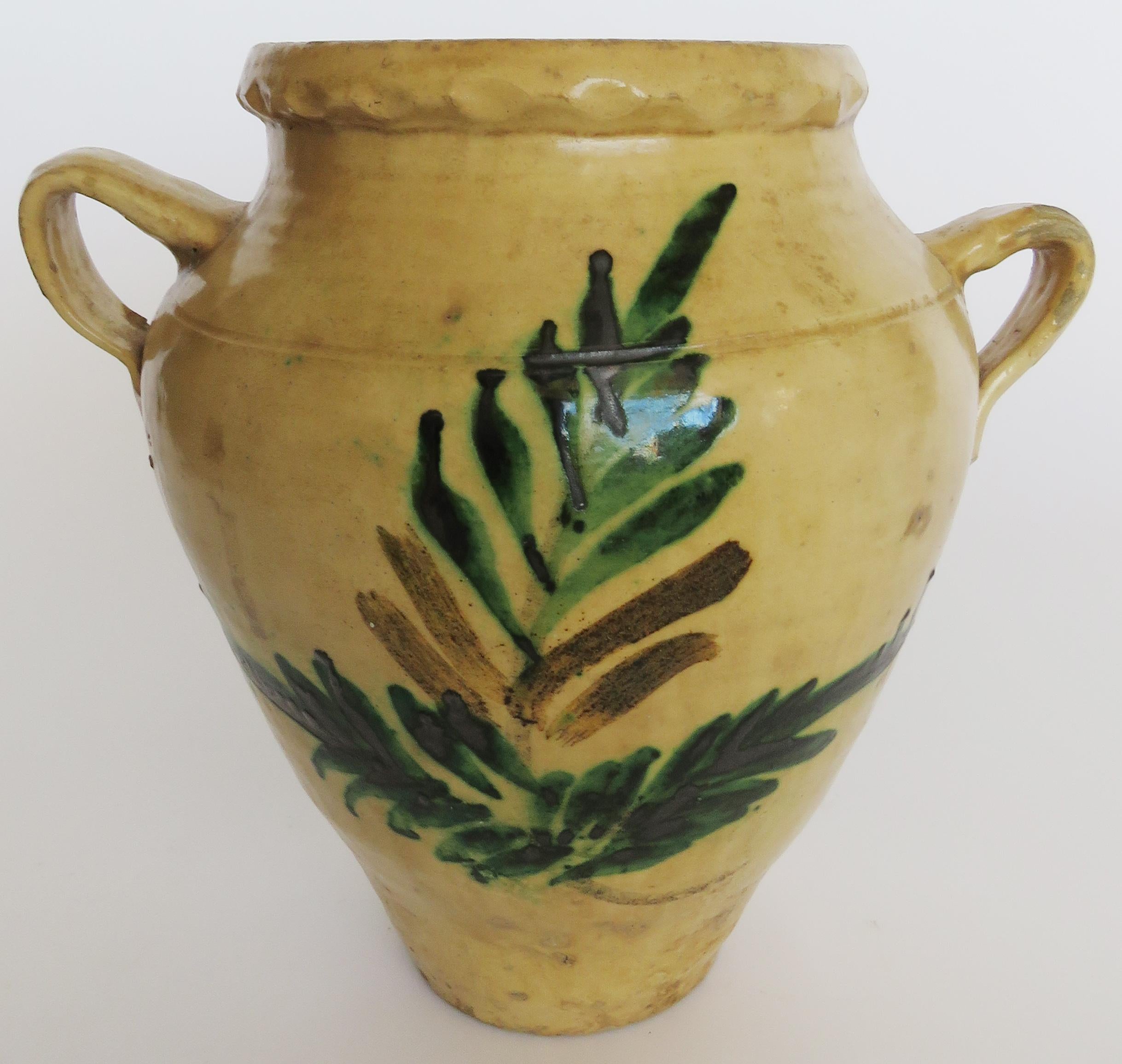 Cream glazed double handle pot with centre Morisco green floral pattern.

 