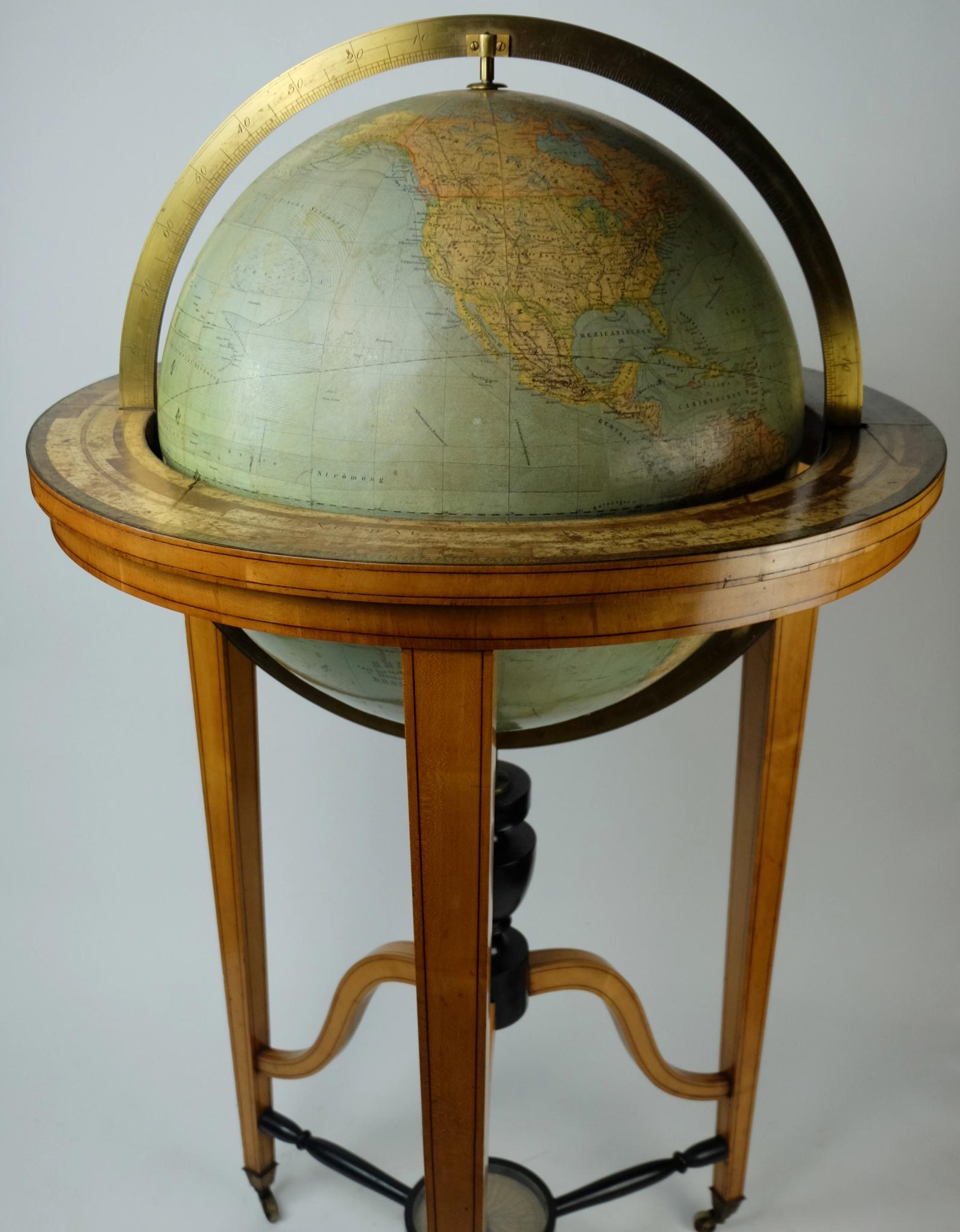 A globe of the firm Ernst Schotte (Berlin, 1861-1940). This 19th century imposing globe has an exceptional format and is equipped with a meridian ring, hour ring, height square and compass. The 3 elegant wooden legs carry a large globe. Language is