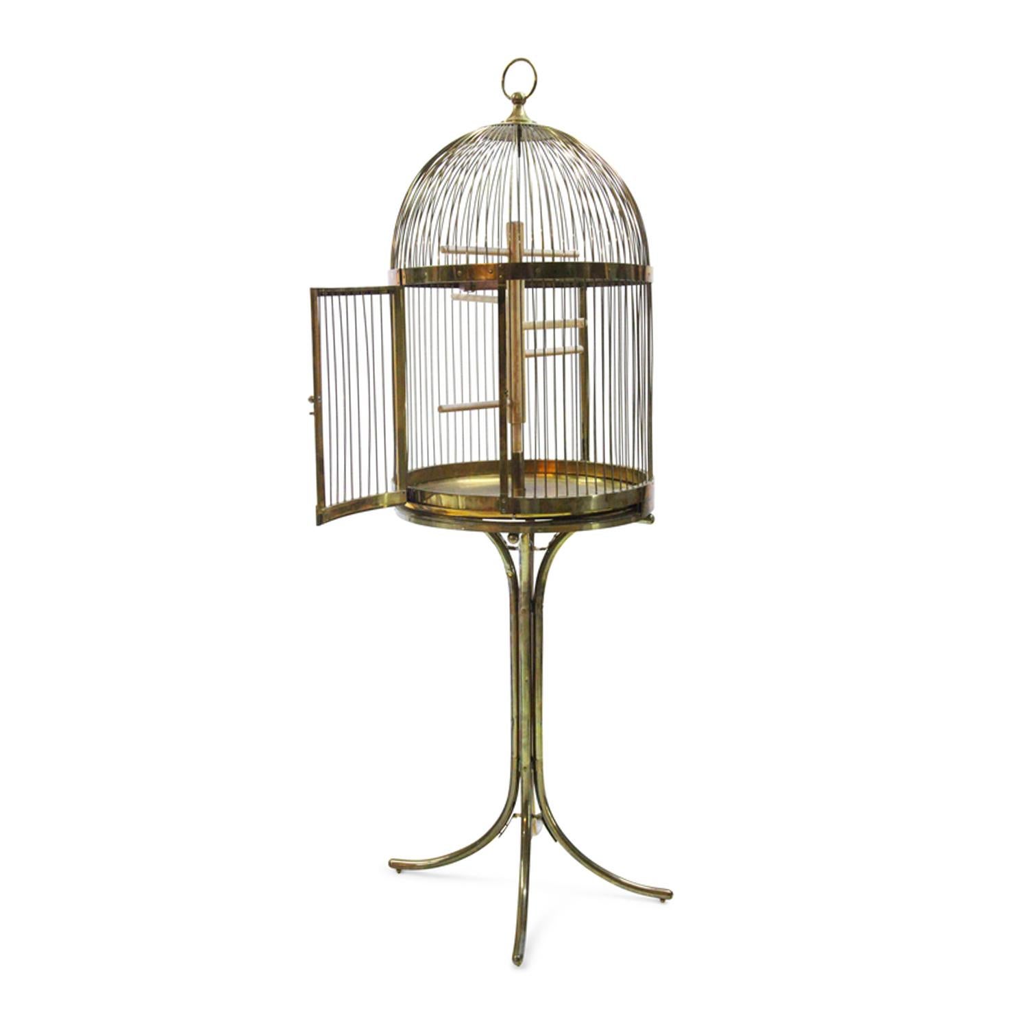 A large antique Austrian birdcage made of handcrafted metal, the vertical lattice struts are made of polished brass, designed by Josef Denk in good condition. The round decorative birdcage is standing on four slightly curved legs. Wear consistent