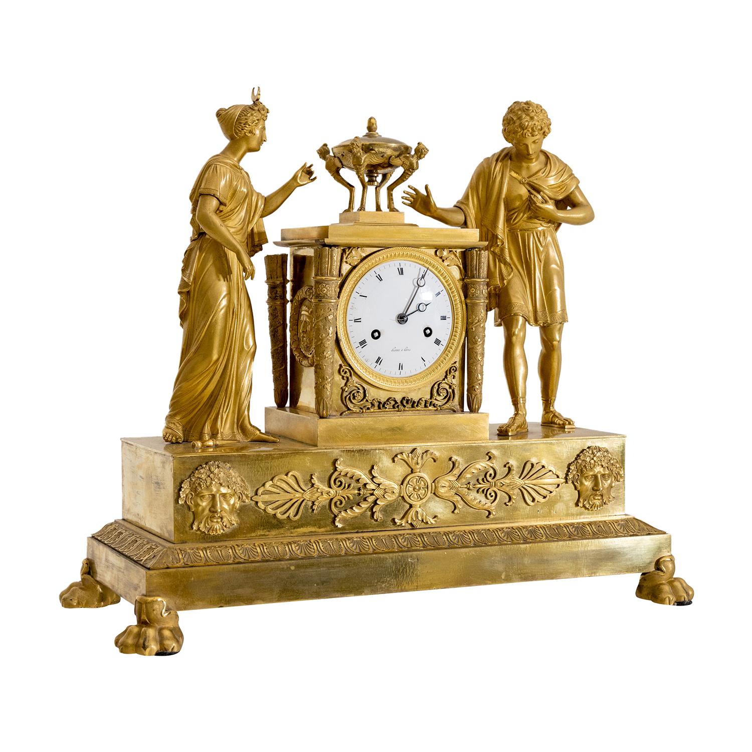 A gold, antique French table clock, pendulum made of hand crafted fire-gilded bronze, in good condition. The circular enamel dial of the Parisian pendule is detailed with Roman numerals on a white background, particularized by a polished bronze