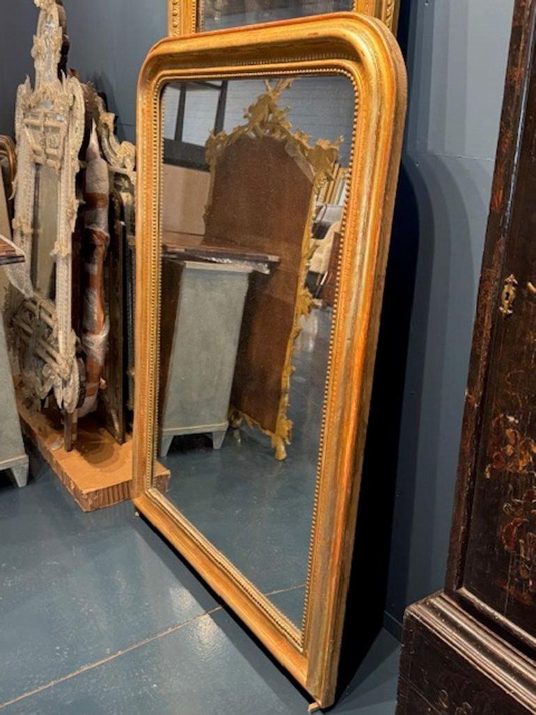 Ce miroir Louis Philippe du XIXe siècle arbore un superbe cadre doré à motif de lignes, ajoutant une touche d'élégance à n'importe quelle pièce. Ce miroir de style classique est une belle pièce qui rehaussera le décor de votre maison. Cet article