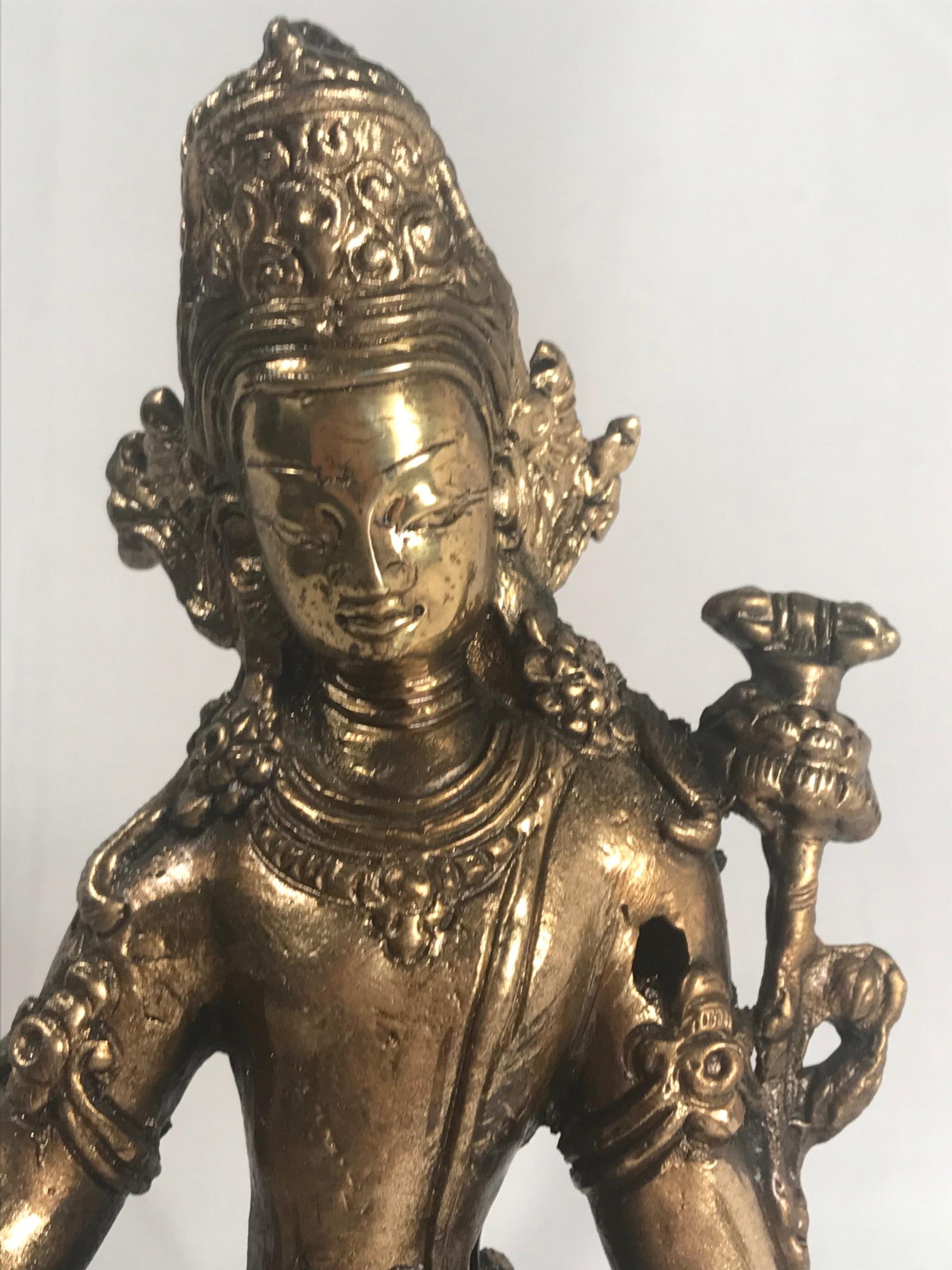 19th century gold gilded bronze Buddha

A finely cast bronze Buddha statue in gold gilt with modeled and incised floral motifs. This jeweled God of Wealth Buddha is seated in lalitasana posture on a lotus with right foot supported on a conch shell.
