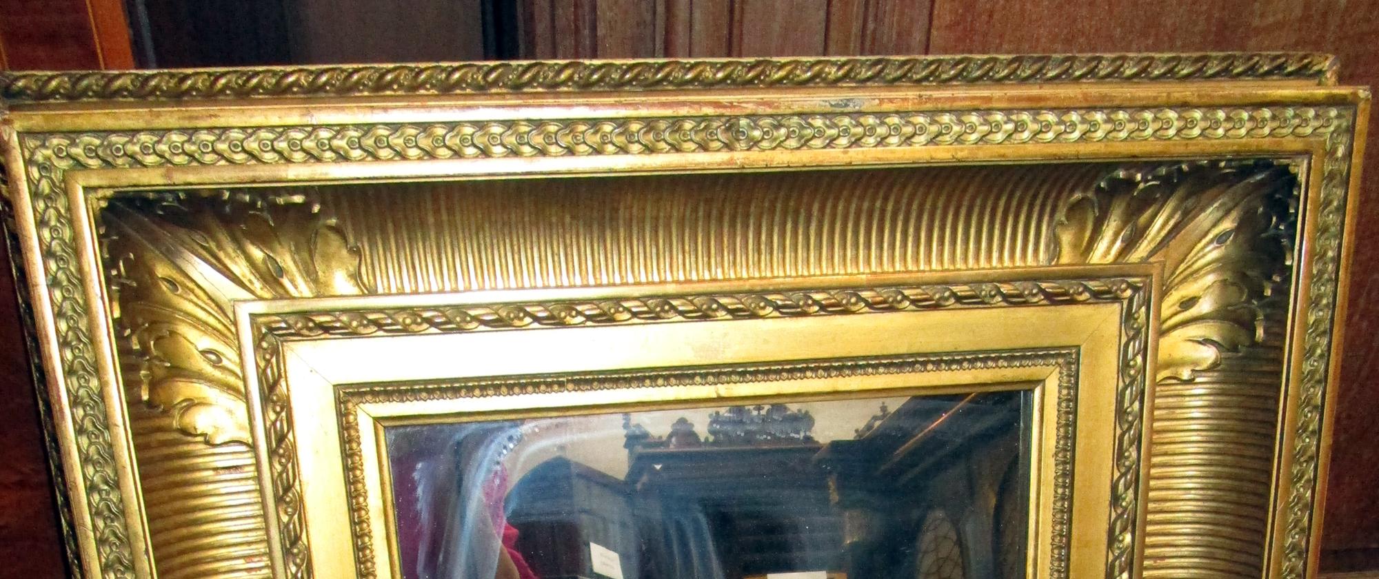 Elaborate gold gilt wooden picture frame converted into mirror. Made by renowned London gilder Charles H. West. His frames hang in the Tate and National Portrait Museum as well as other important museums throughout the world. Very detailed featuring