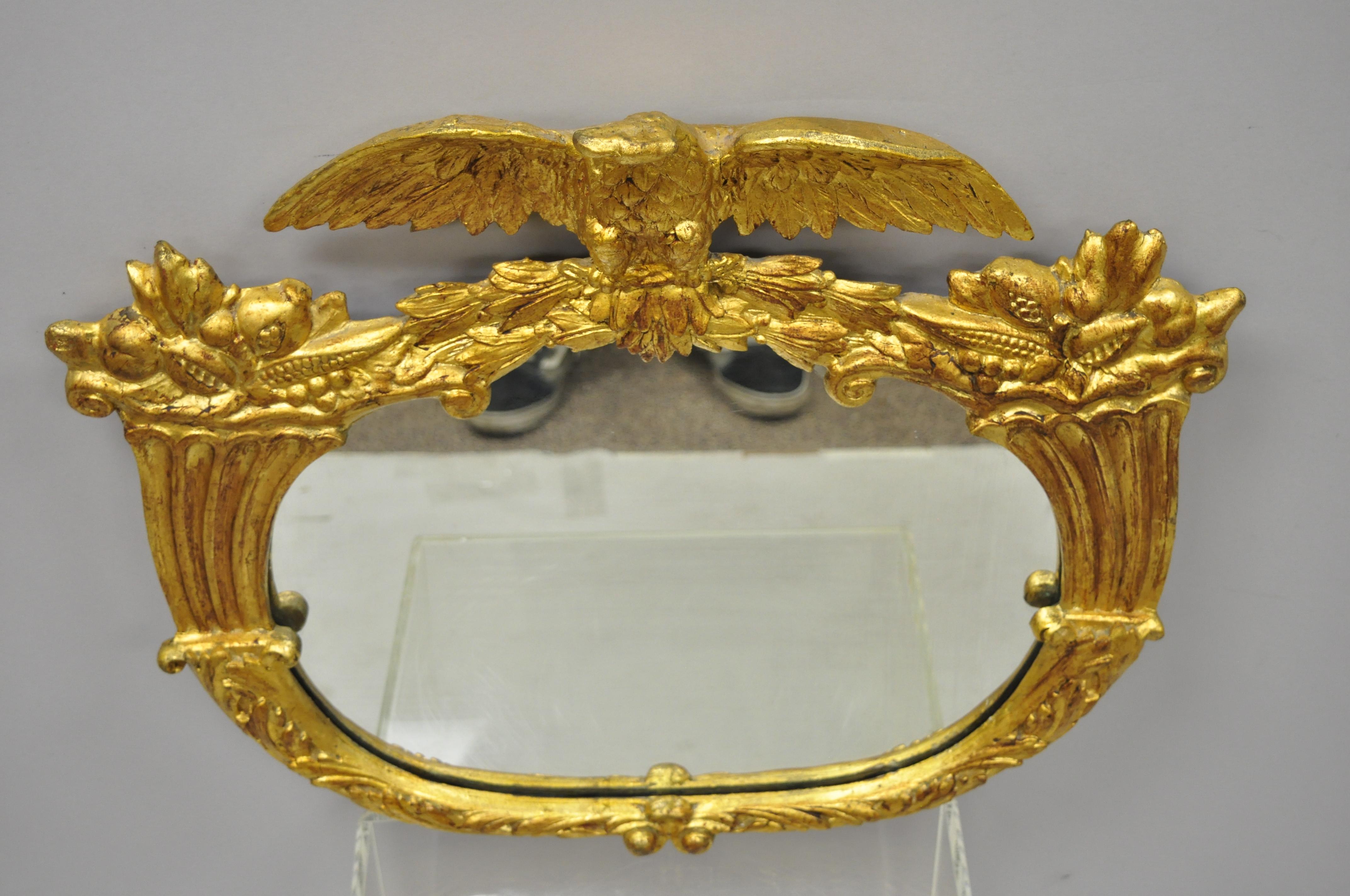 19th century gold gilt Gesso Federal style eagle wall mirror with cornucopia. Item features gilt gesso eagle crest and cornucopia frame, oval central mirror, very nice antique item, great style and form, circa 19th century. Measurements: 23