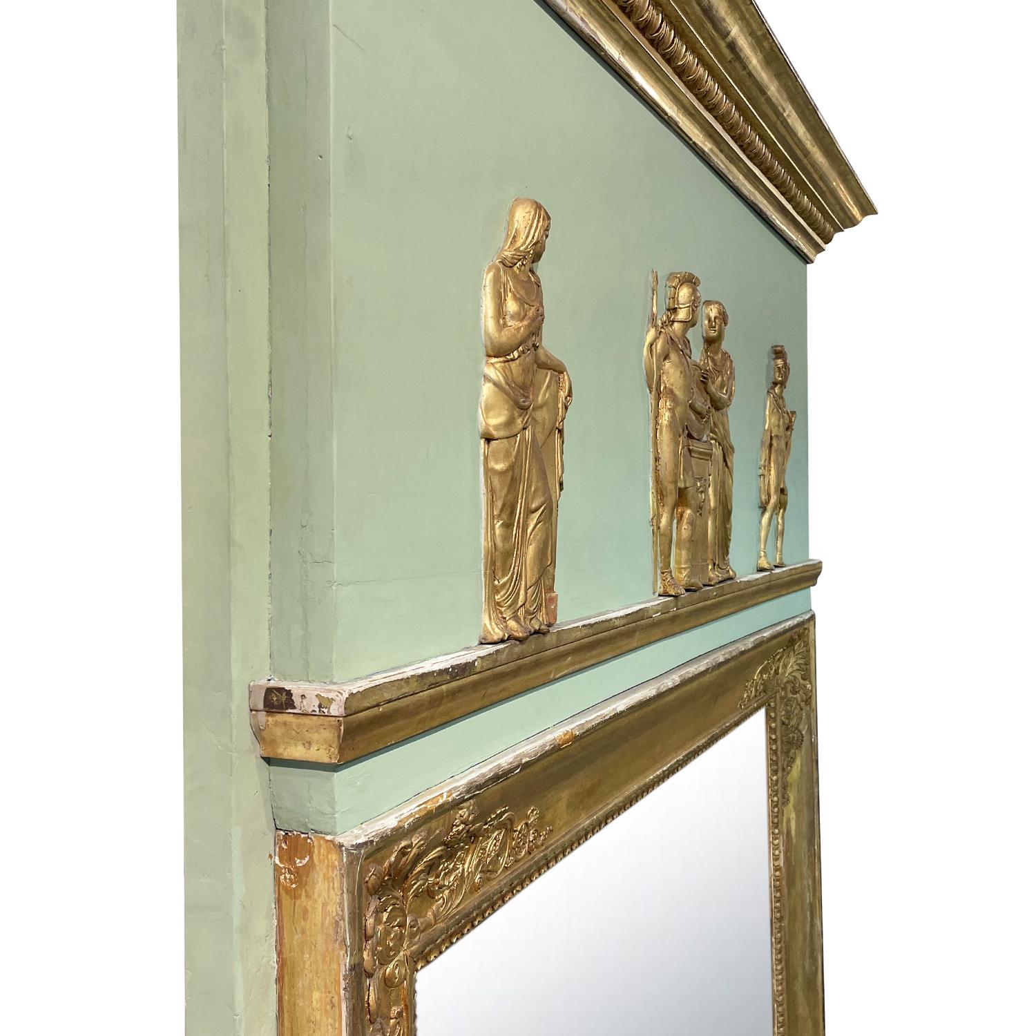 A gold-green, antique French large patinated Trumeau mirror made of handcrafted Giltwood with its original mirror glass, in good condition. The wall décor piece is enhanced by detailed cornice as well as a gilded frieze with figural scenes,