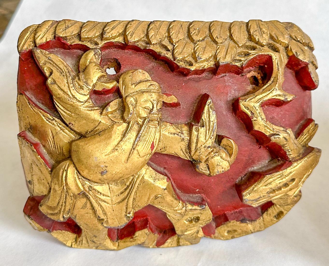 Offered are a pair of oxblood red and gold leaf architectural fragments, most likely Chinese; origin unknown. An unusual find, given the distinct right and left facing nature of the carved ornamentation. Both have foldable easel backs for display.