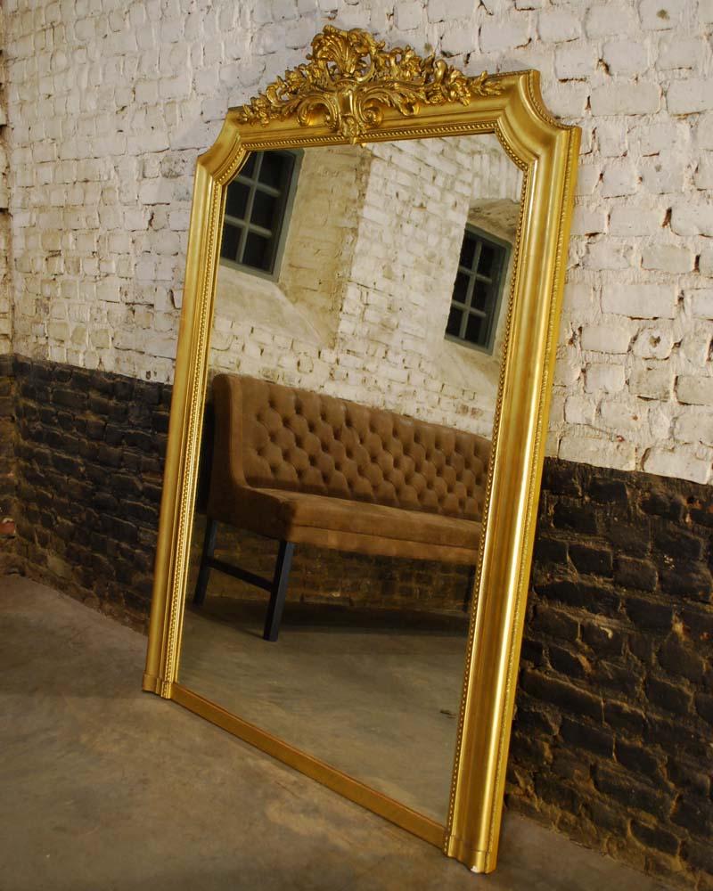A beautiful antique gold leaf gilt mantel mirror in Louis Philippe style. 
The frame is completely gilt with gold leaf and the gilding is in a very good shape with a very strong gold color.
Parts are polished to create a different shade of gold.