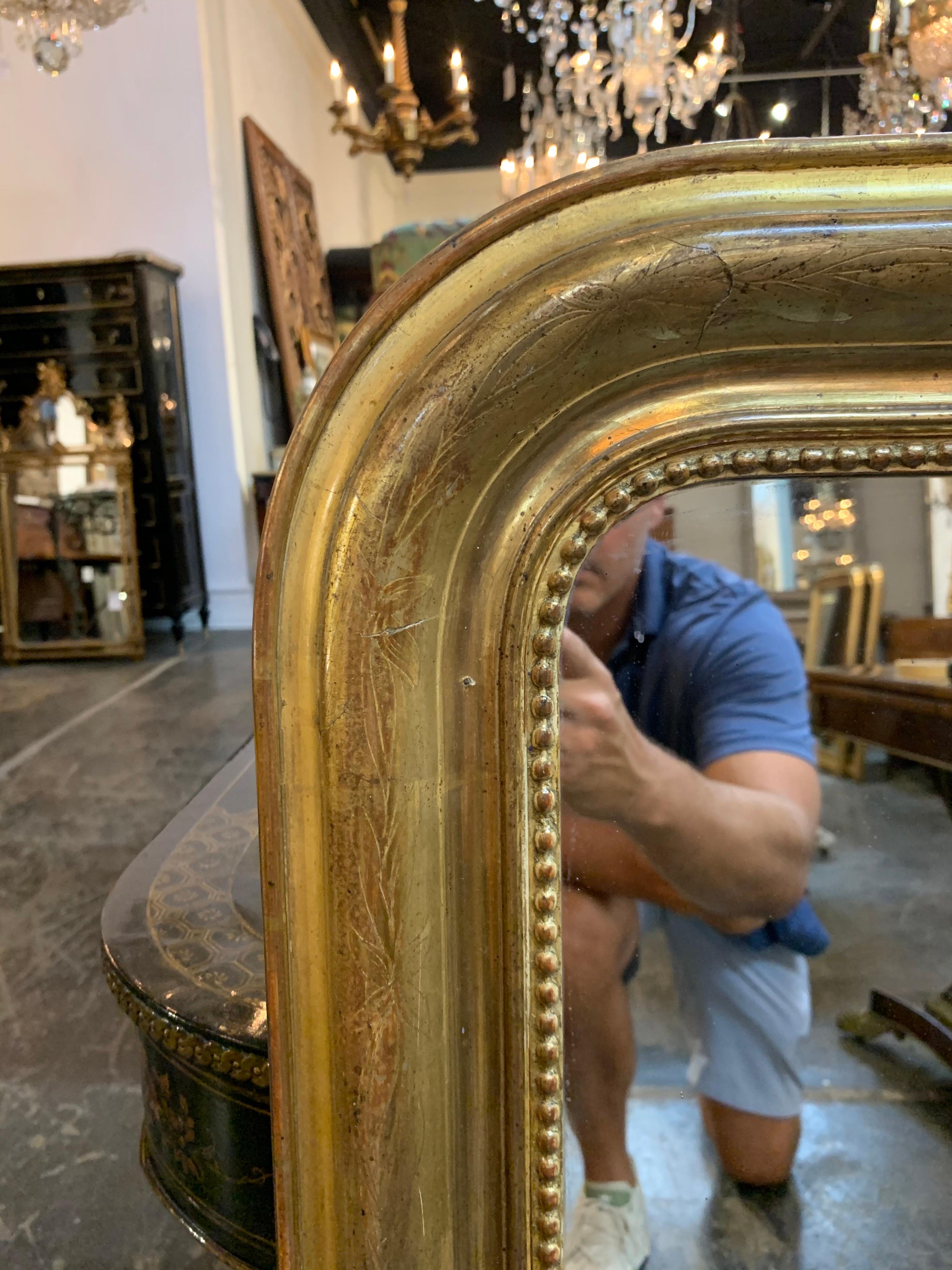 Very fine 19th century gold Louis Philippe mirror. Pretty polished finish with a floral pattern and an inner beaded border. A great addition to an elegant home!