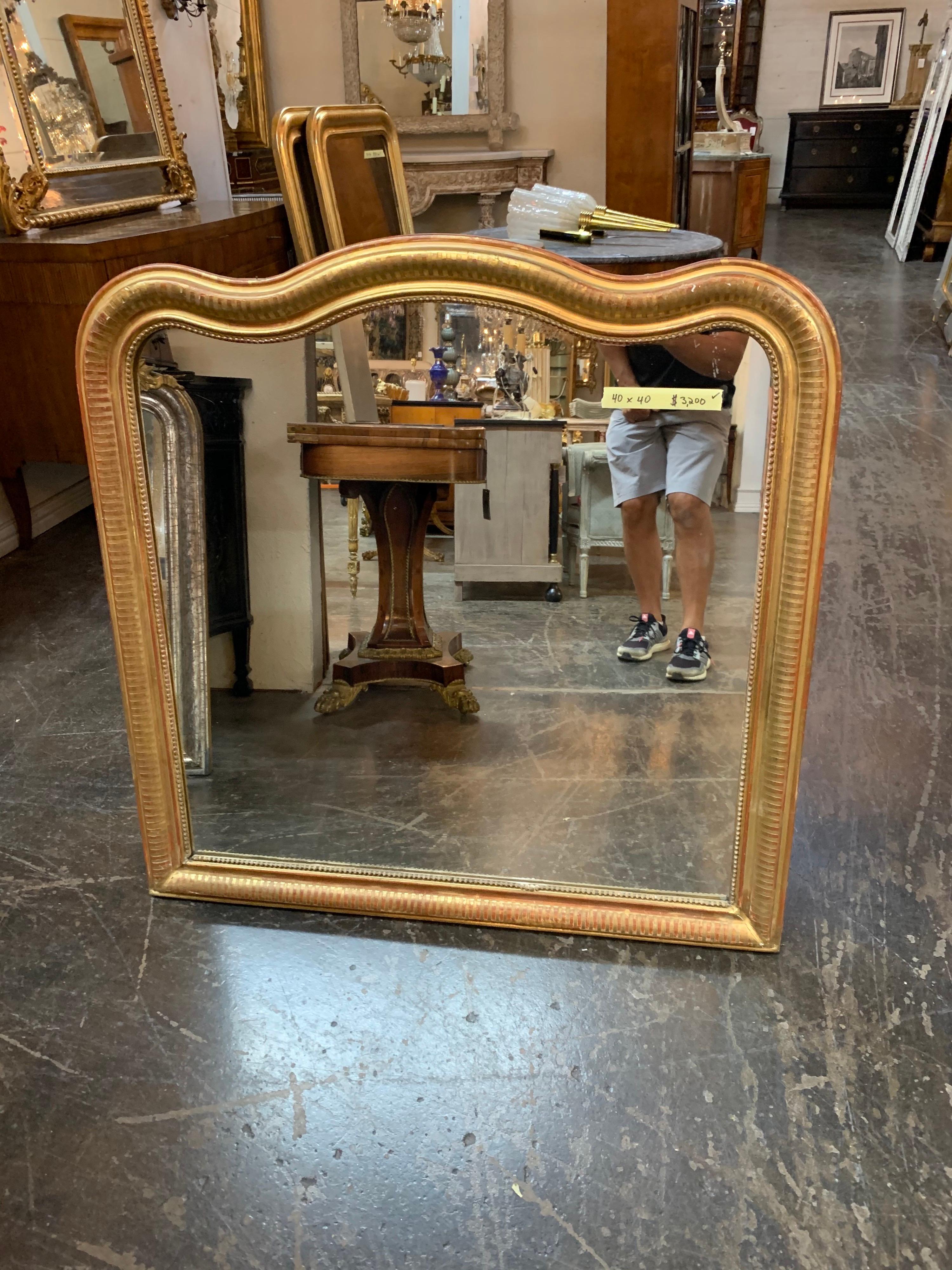 Nice 19th century gold Louis Philippe mirror with bar pattern and red undertones. Rare wide size on this mirror. 
Very pretty!!