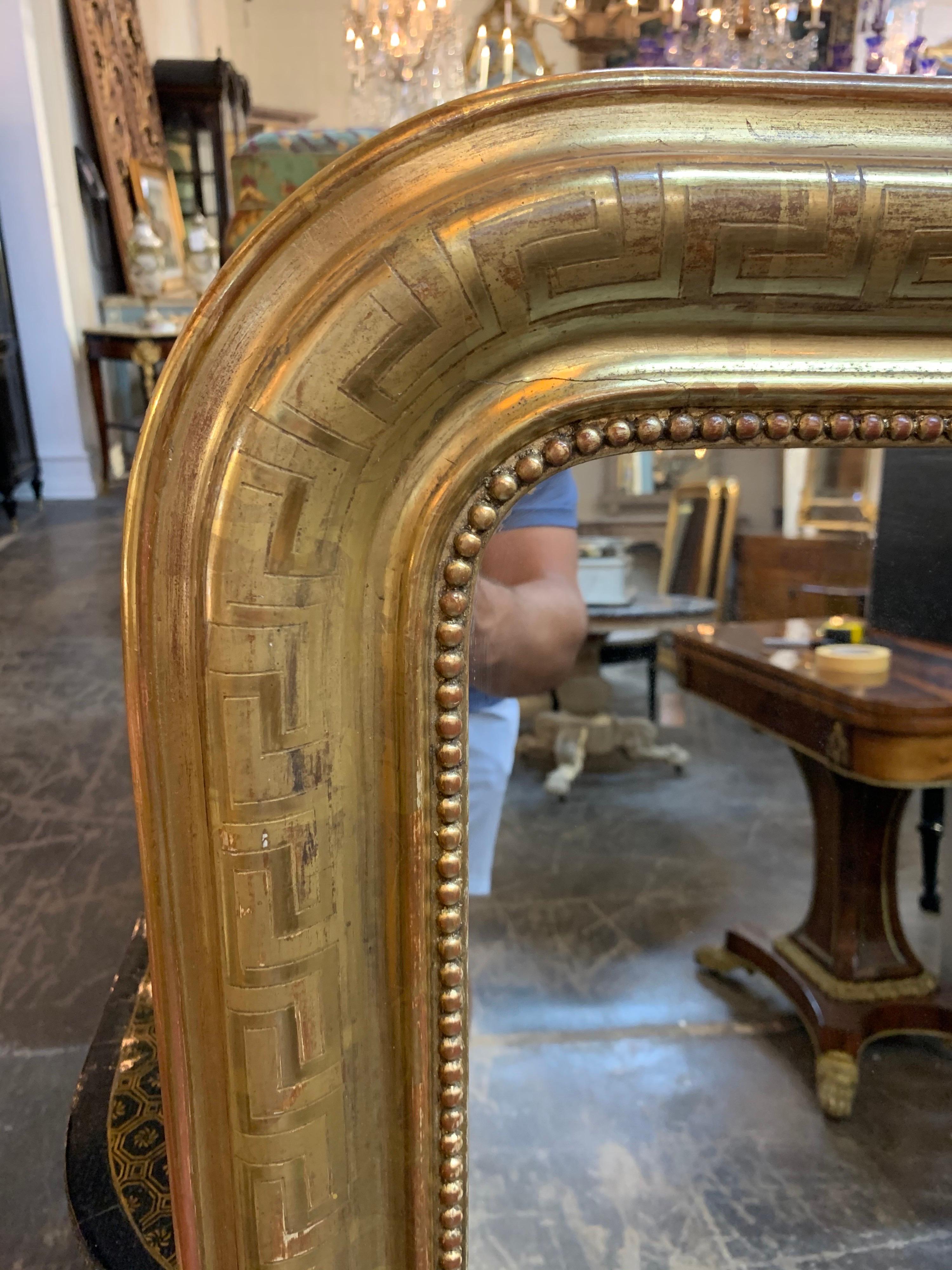 Fabulous 19th century gold Louis Philippe mirror with Greek key image. This mirror has a beautiful finish with slight red undertones and a beaded inner border. Extra special!