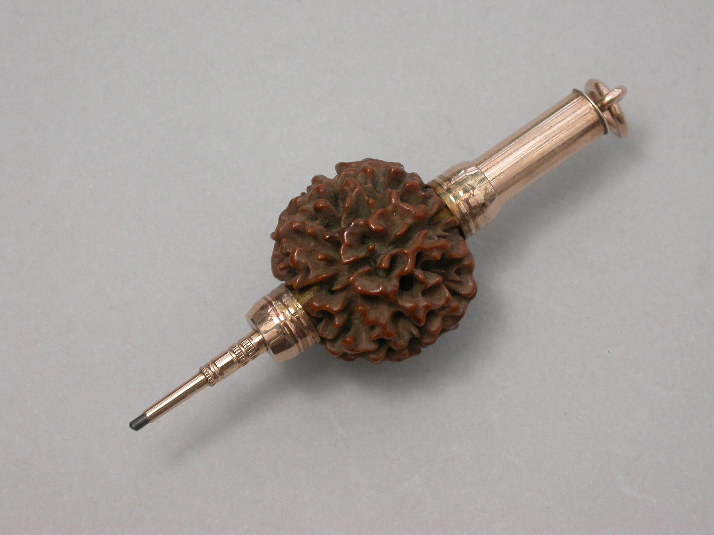 A late 19th century gold mounted novelty telescopic Propelling Pencil formed from a Rudraksha Seed with attached suspension ring.

Unmarked, circa 1880.

Open 58 mm
Closed 32 mm 

In good condition with no damage or repair and in full working