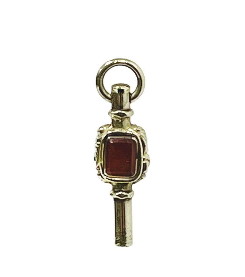 19th century gold Watch-Key with each side a different stone

A watch-key, gold with each side a different stone. On one side a carnelian stone and the other side a light greenish clear stone set in a floral rectangular golden floral setting. Dutch