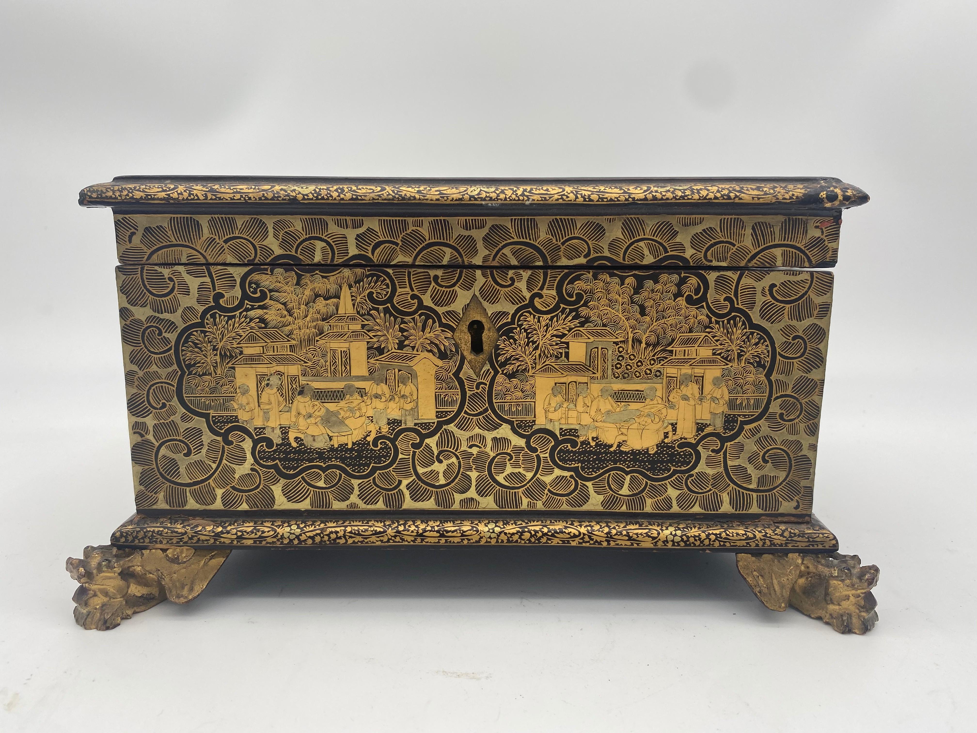 19th century lift-lid gilt-decorated golden black lacquer Chinese jewelry box with dragon feet and key.