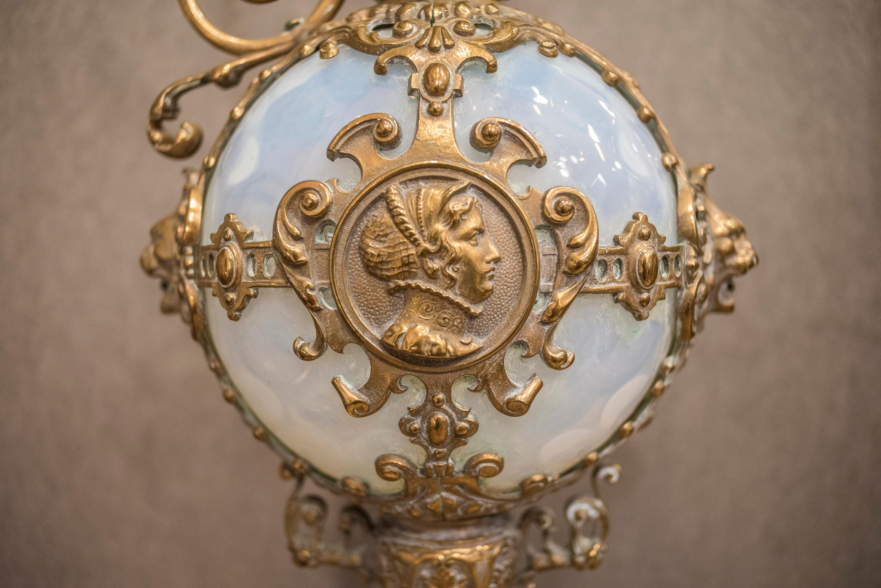 One of a kind 19th century, golden bronze (ormolu) and opaline white glass Spanish baroque style Amphore. With a medallion on the obverse with a female portrait and an other
medallion on the reverse with a male portrait, all worked on the
