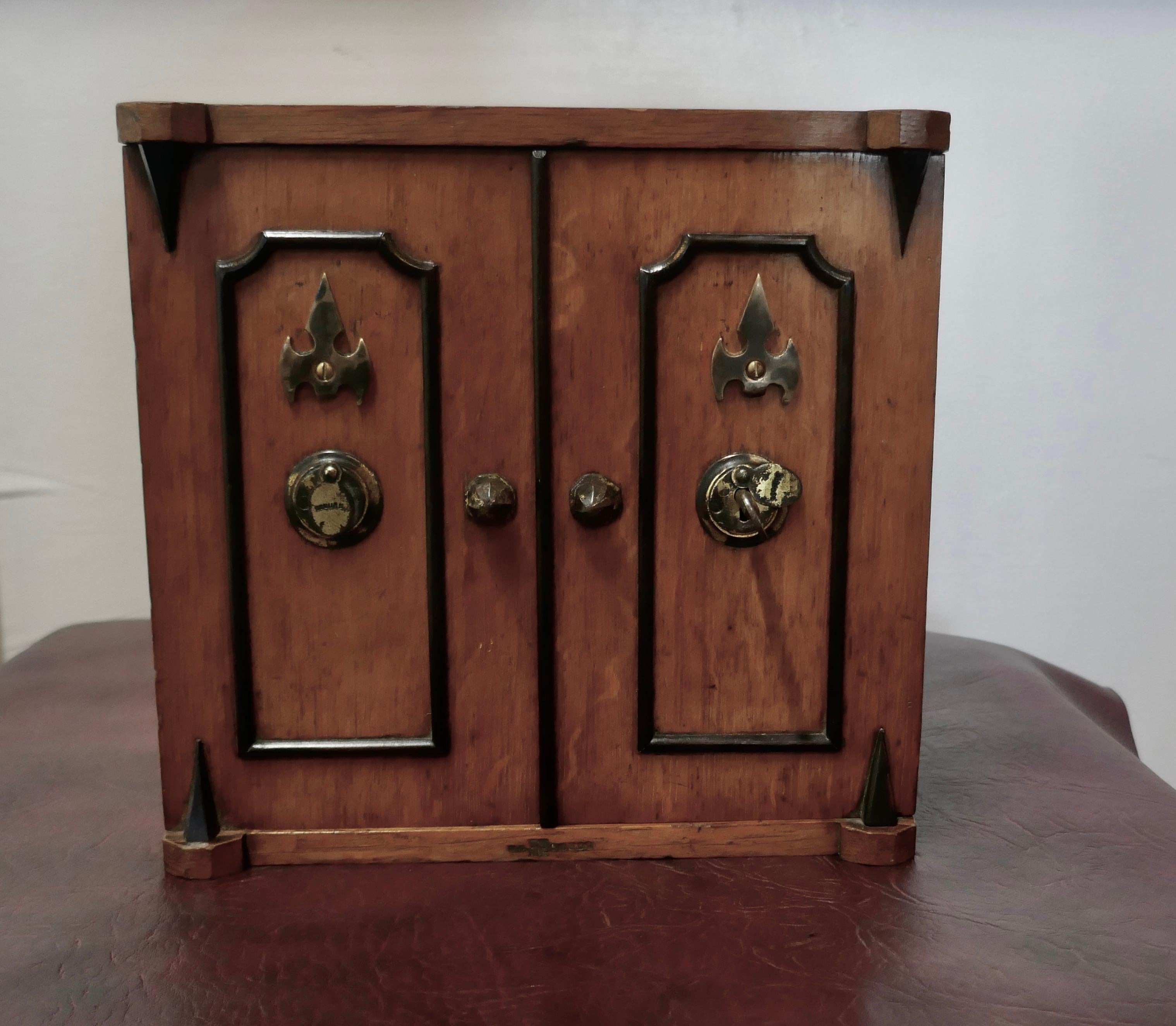 19th Century Golden Oak Humidor

A  great fun piece dating from 1870, designed to look like a bank safe 
The Cigar box has 3 drawers to the interior and brass fittings inside and out, it is in good attractive condition, it is 10” high, 10” wide and