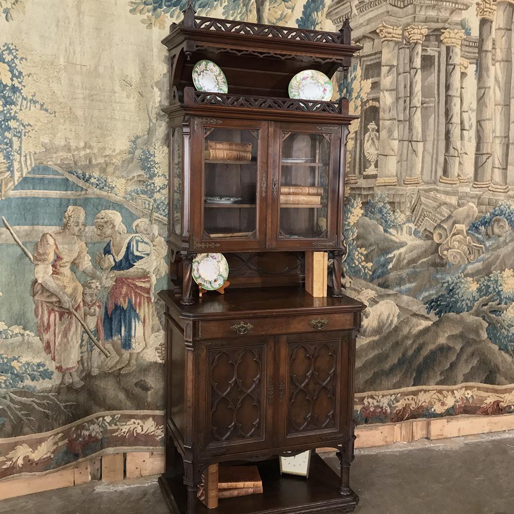 19th century Gothic dessert buffet or vitrine is a study in architectural grandeur that dates back to its roots to 12th century France! The pierced gallery rail on top is mirrored by a pendant style molding treatment with spires on the cornerposts,