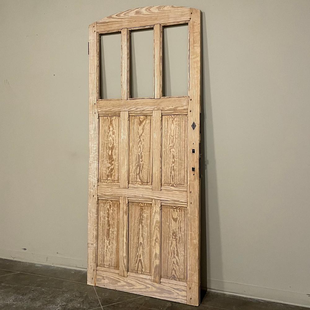 19th century Gothic double-sided solid pine exterior door was crafted from solid pine which has been fully stripped and ready for staining or painting to complement your project! The subtle arched design features three vertical panes at the top