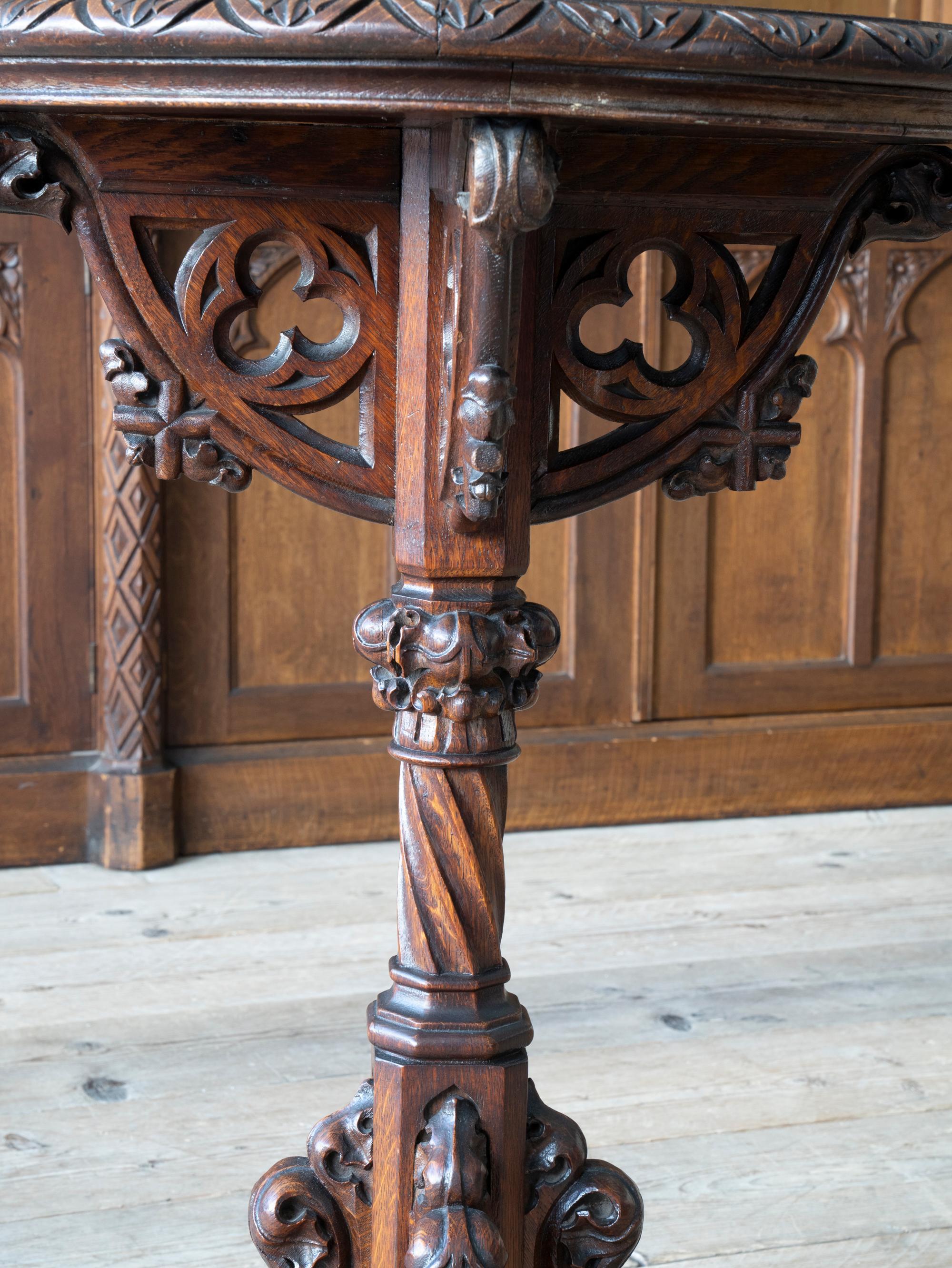 The circular parquetry top above trefoil pierced bracket supports, turned pillar on splayed legs with carved leaf decoration in the manner of A.W.N Pugin.